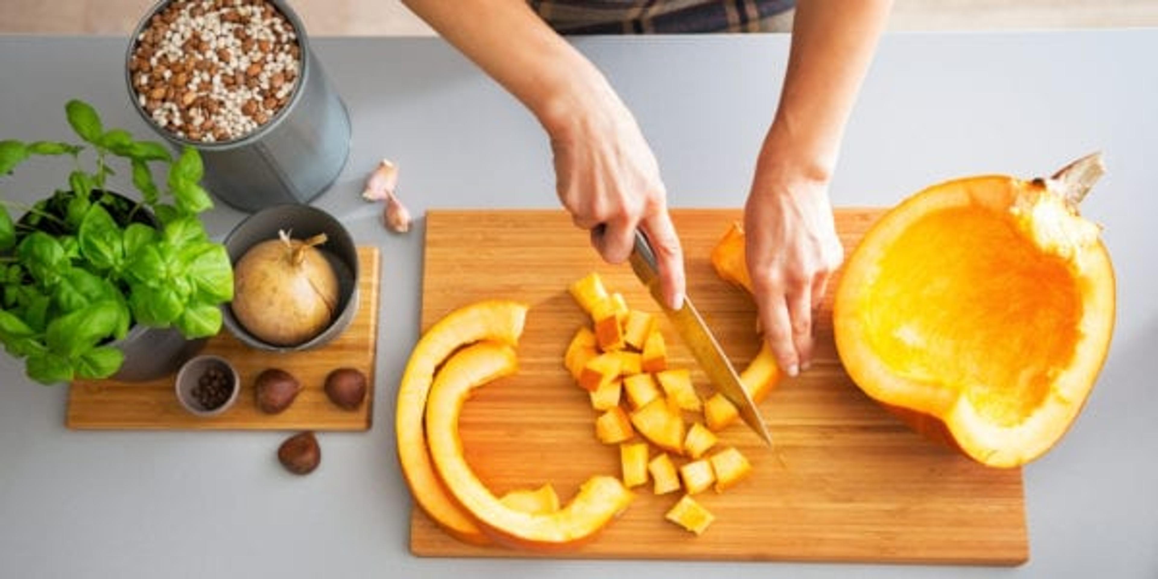 Woman prepping pumpkin to cook