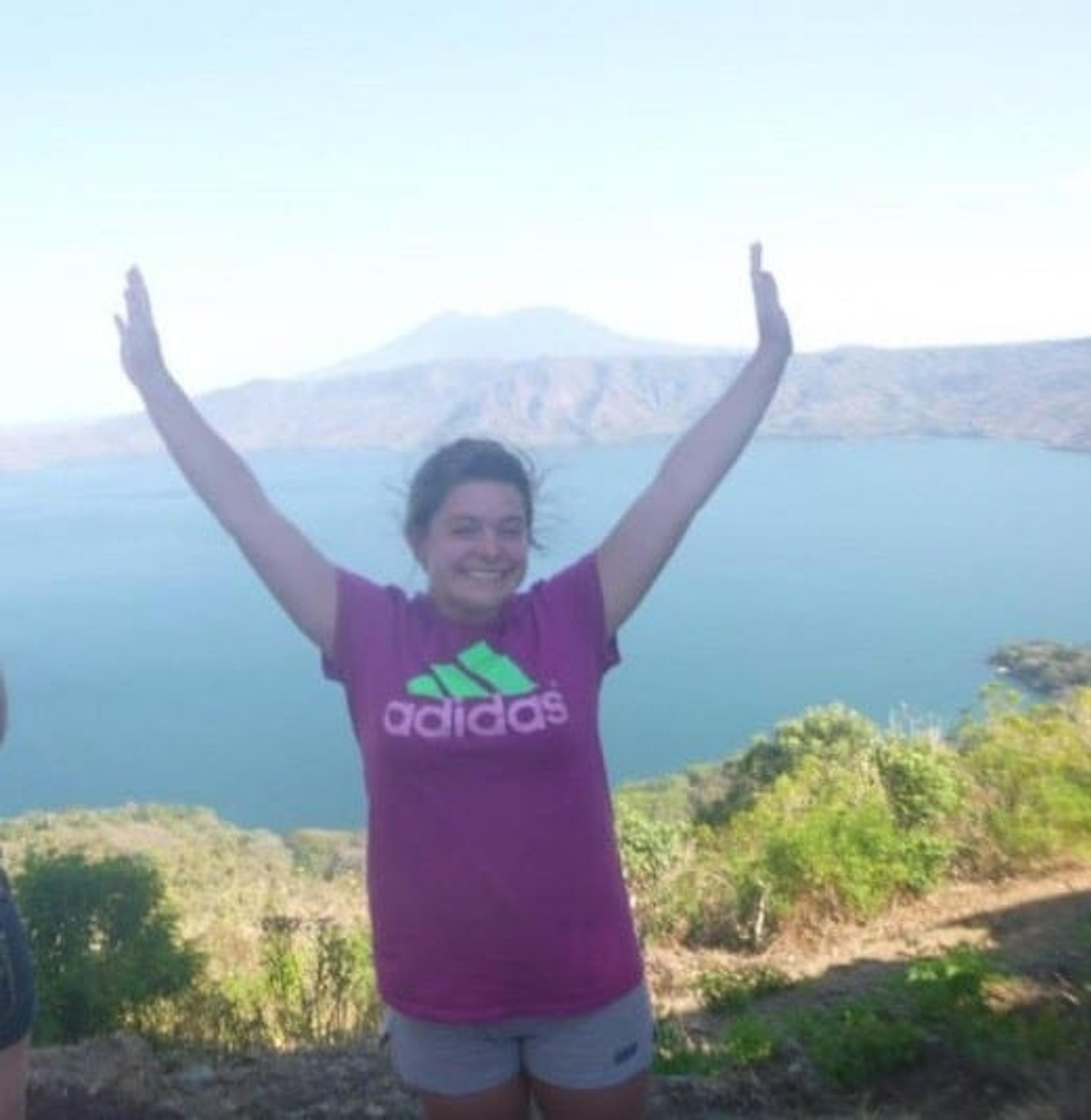 Image of Ashley Heitzman with arms raised over head in Costa Rica.