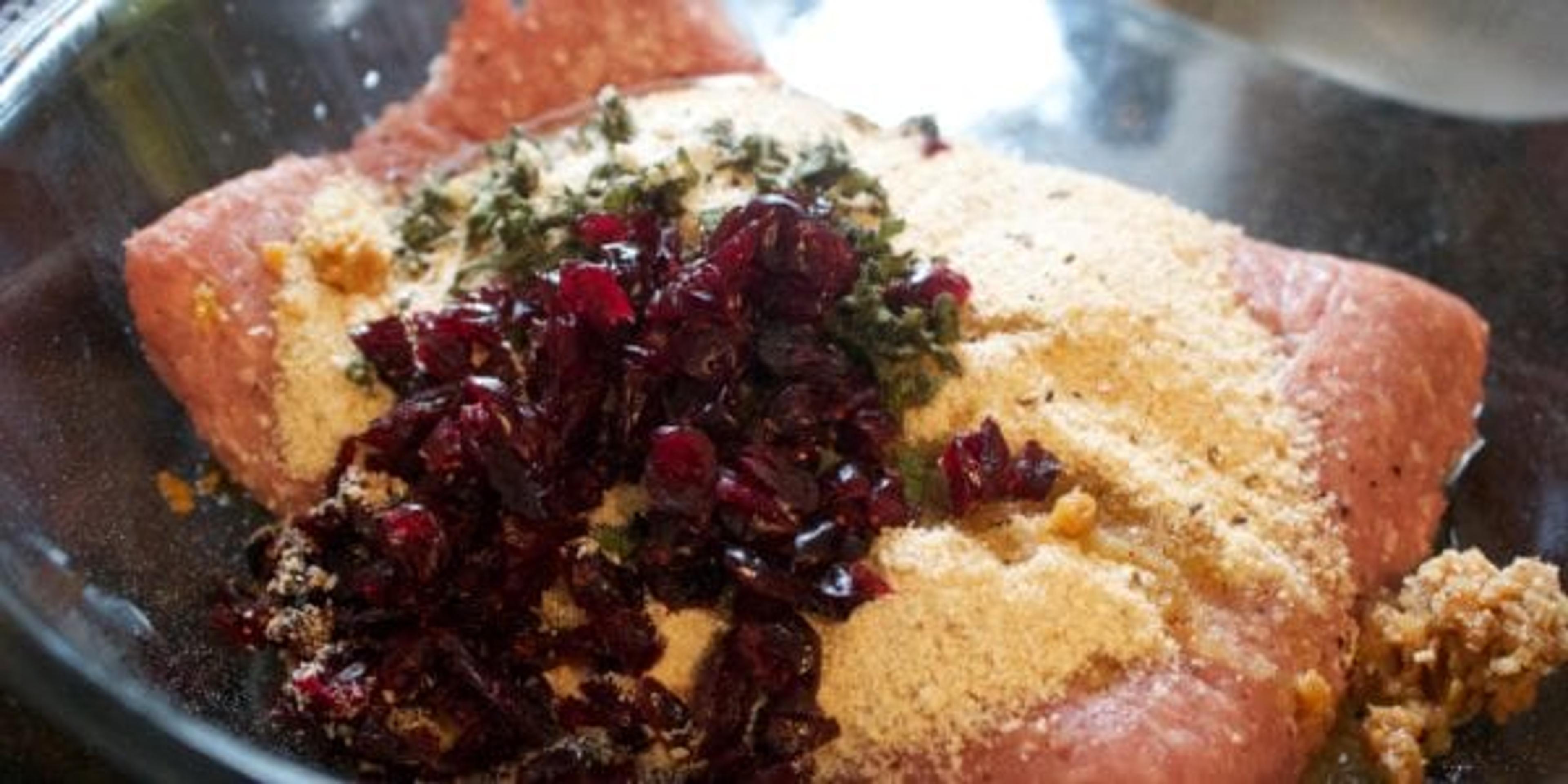 Patties in a silver bowl with cranberries on top