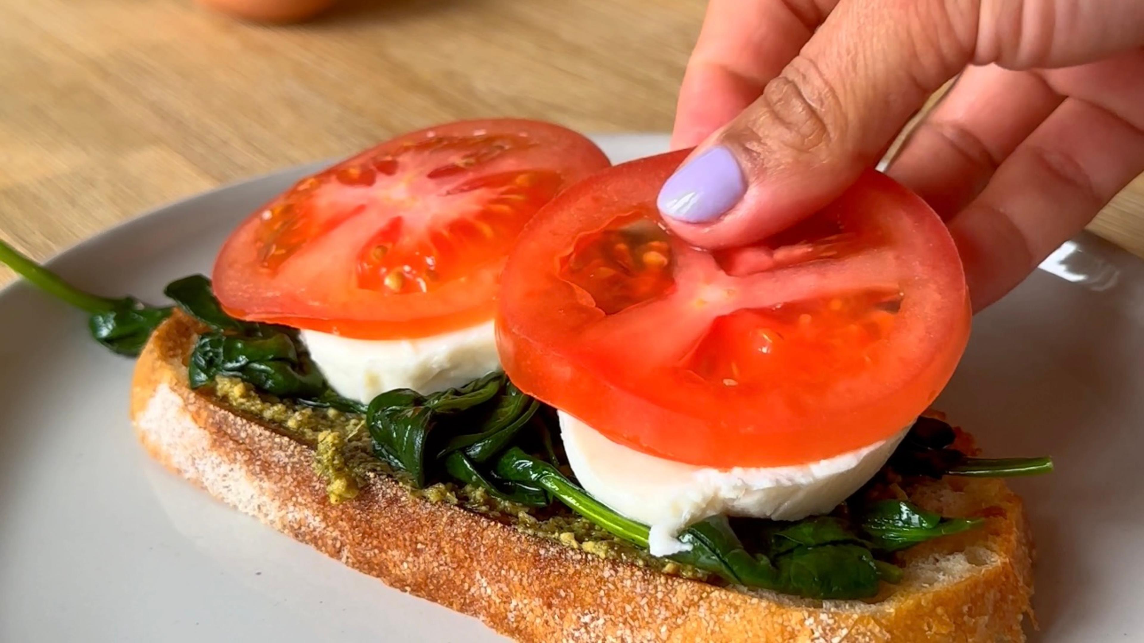 Pesto, spinach, mozzarella, tomato and egg on sourdough toast with fresh cracked pepper.