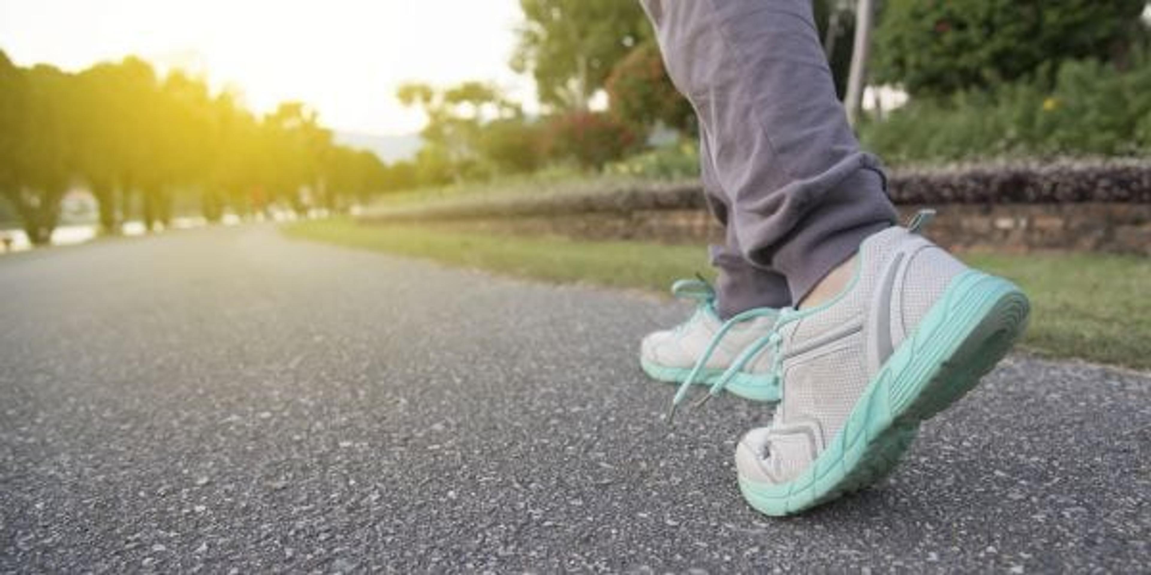 Road to success,running on road with sports shoes,healthy lifestyle sports woman running, female legs with sneakers jogging in evening