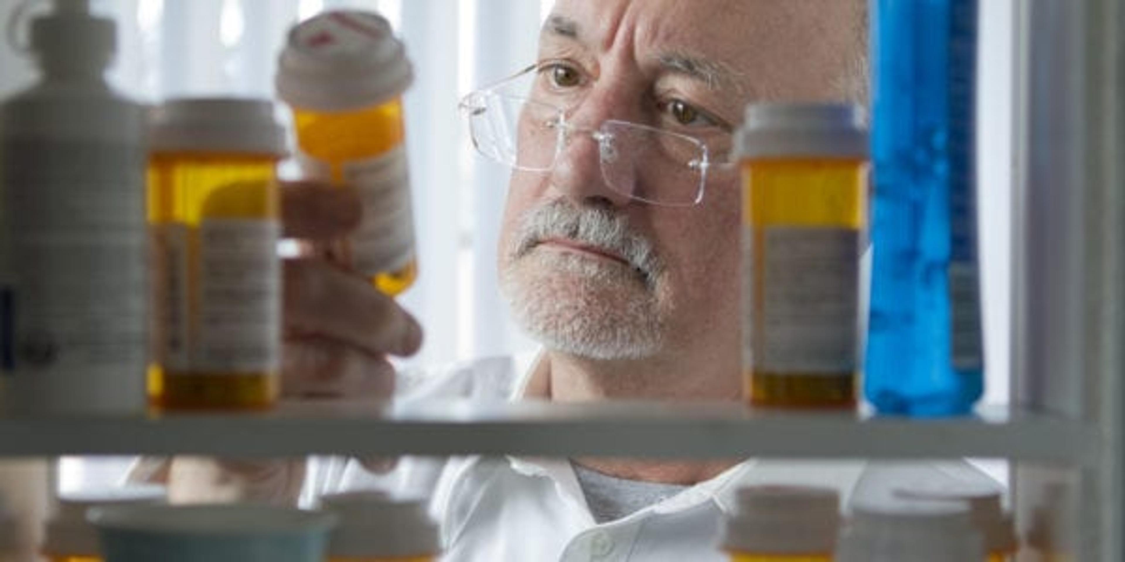 Senior man looking at prescription drugs