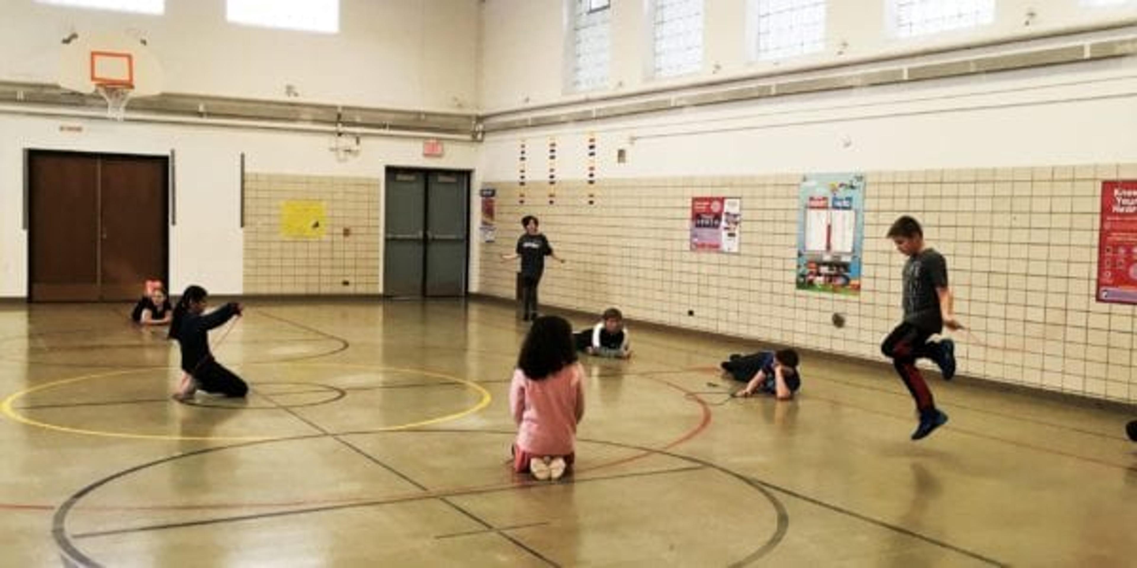 Children jump rope in a gym