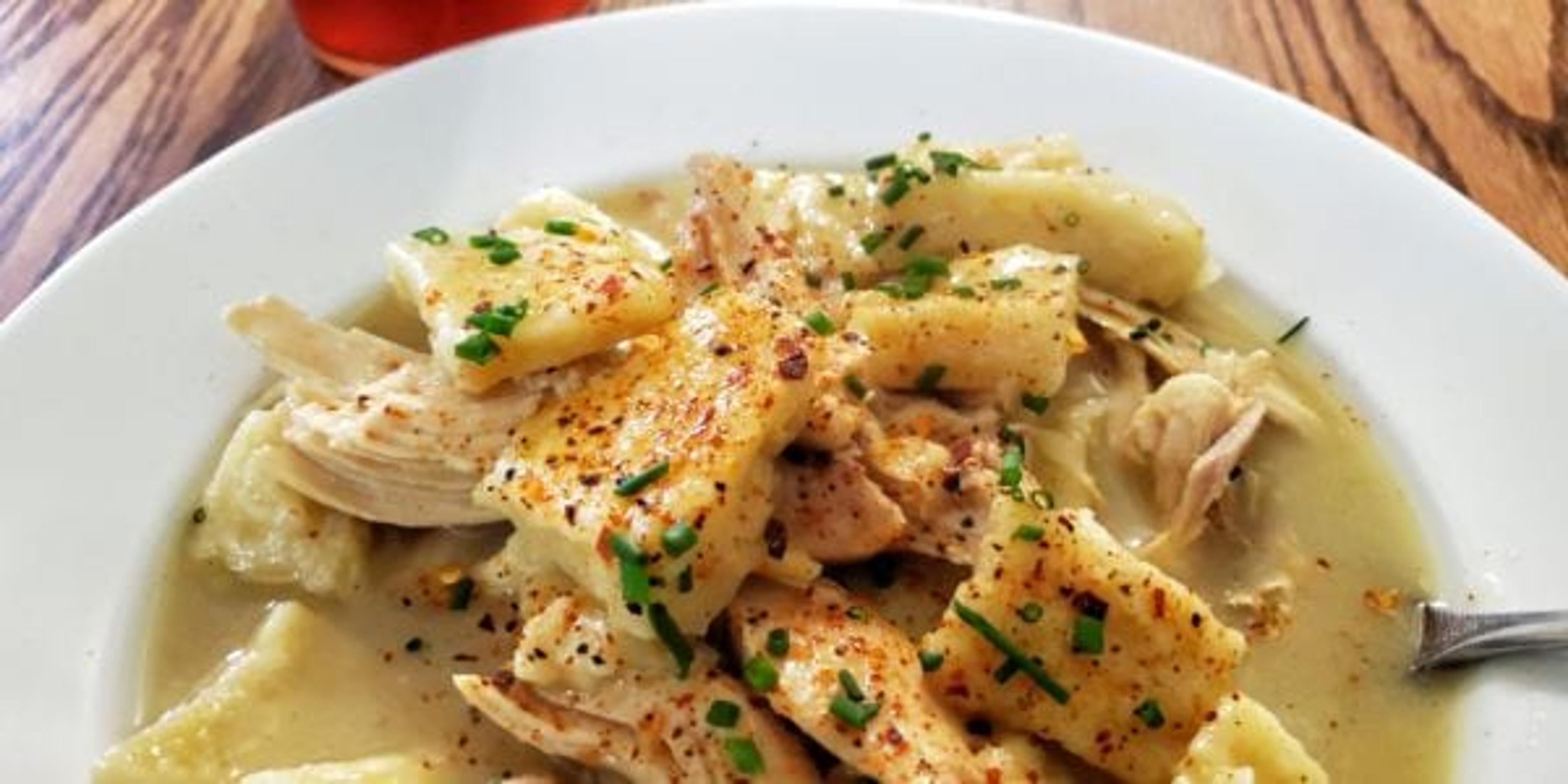 A bowl of chicken and dumplings.