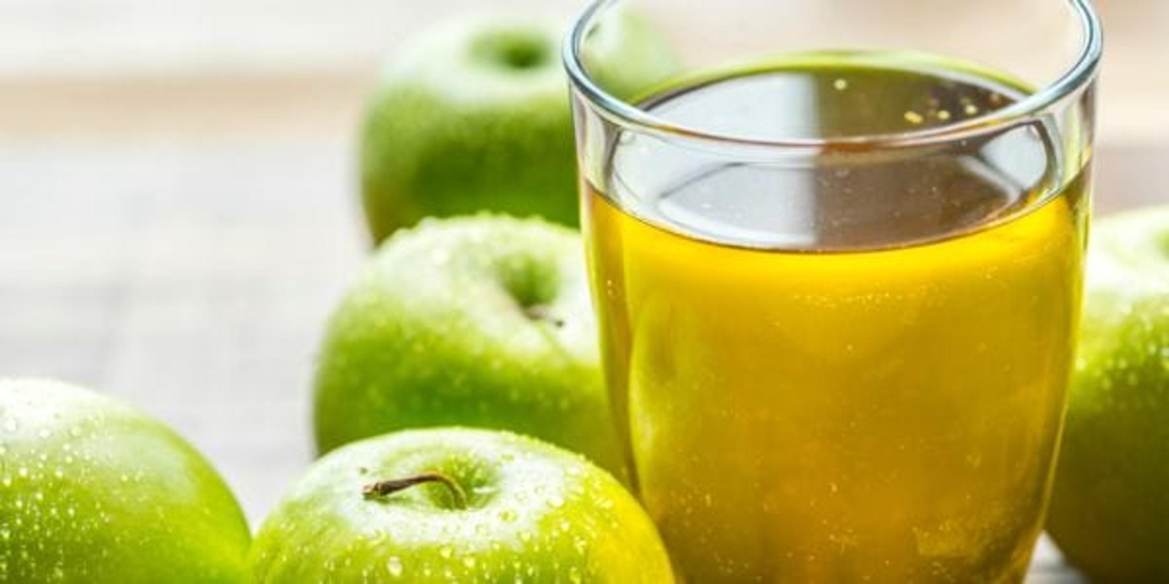 Green aples next to apple cider