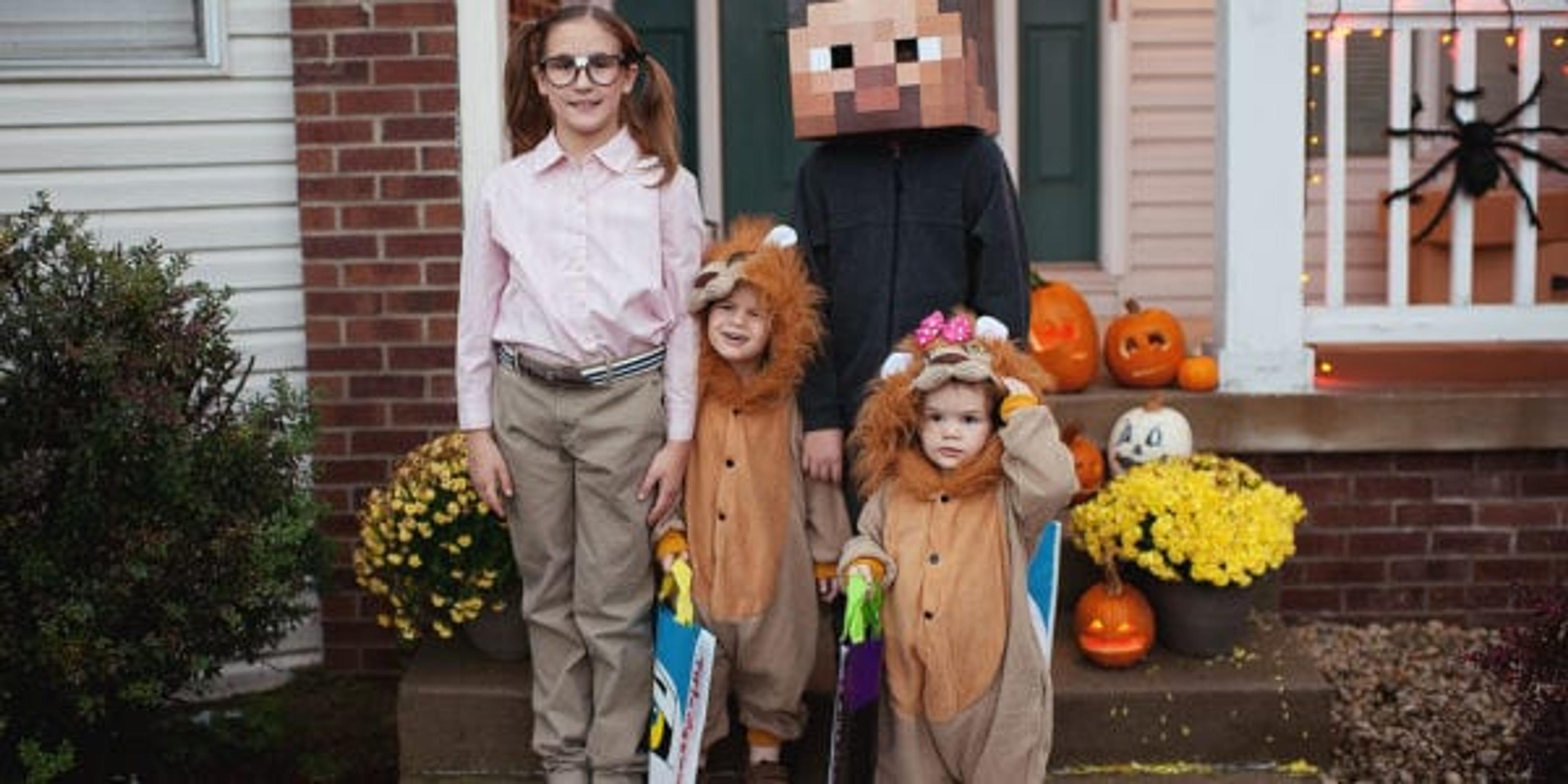 Image of four kids dressed up for Halloween.