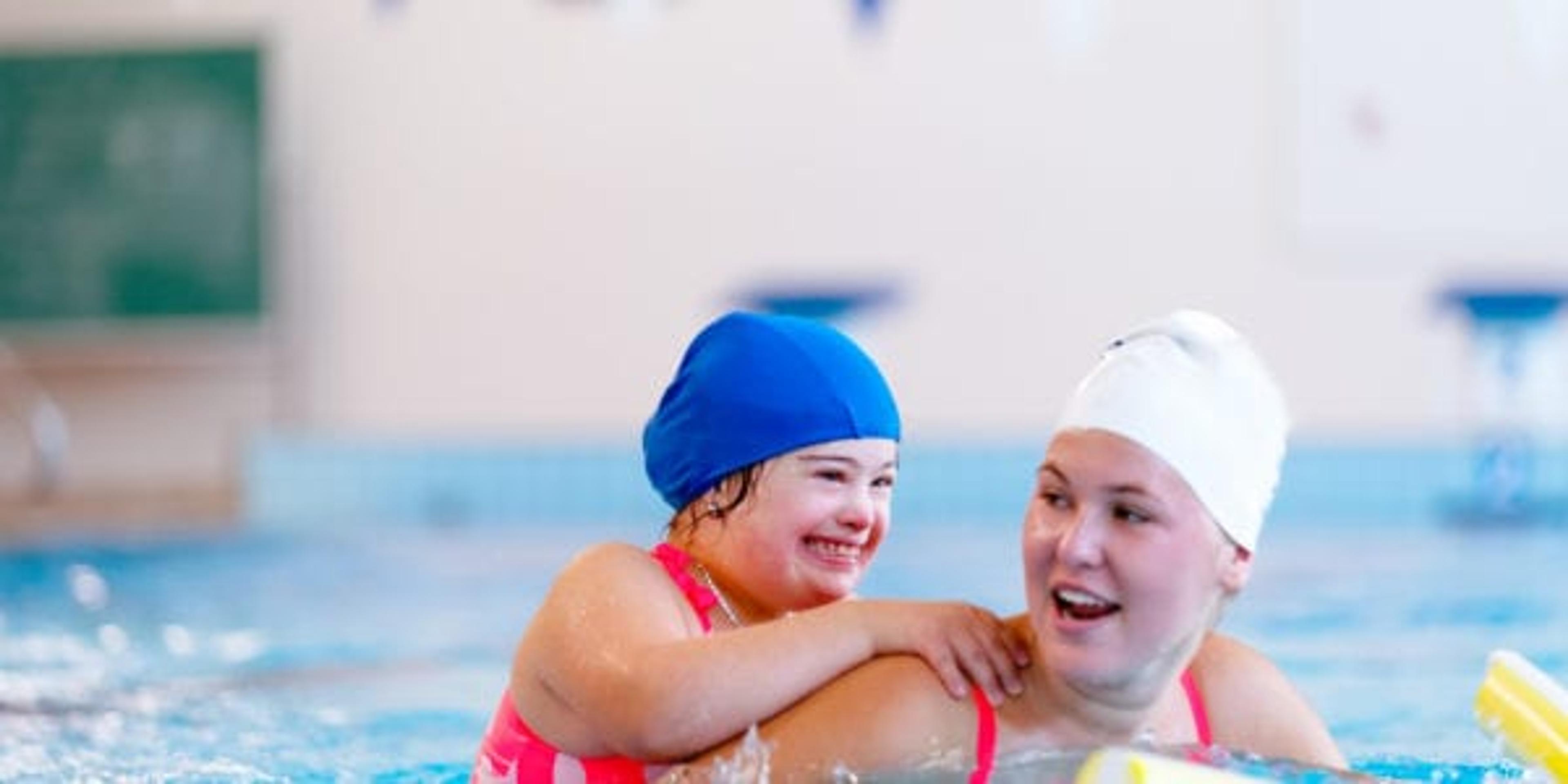 Day in the life of a family 4 children including 1 little girl with Down syndrome and autism and her adopted little brother, Down syndrome and autism too, a big brother and a baby boy. The little girl with Down's syndrome follows a swimming lesson with a coach Photo was taken in Quebec Canada.