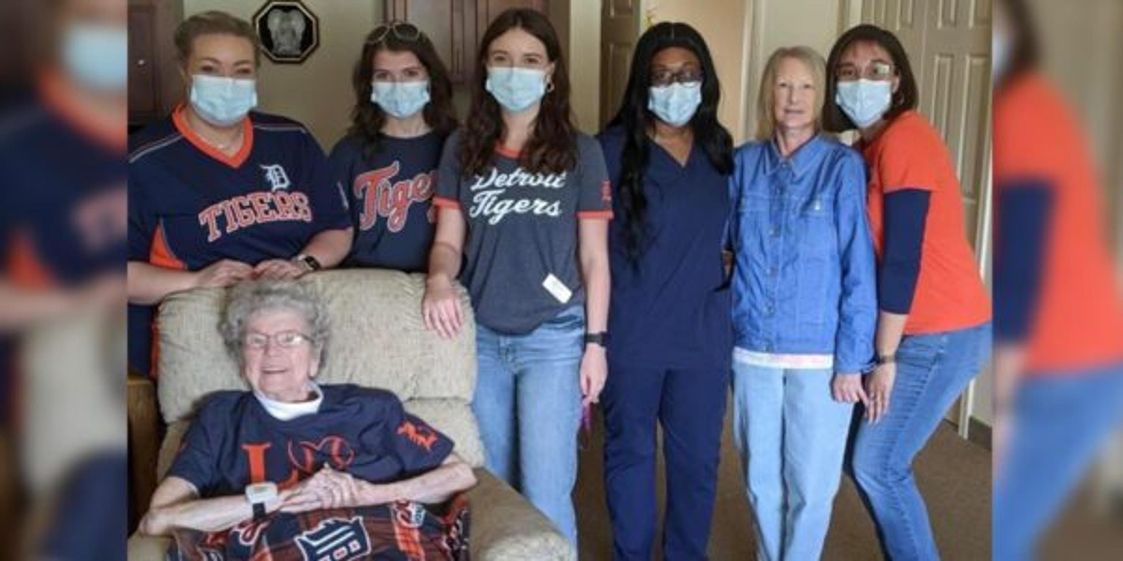 Eva Martin poses for a photo with caretakers at Crestwood Village Assisted Living.