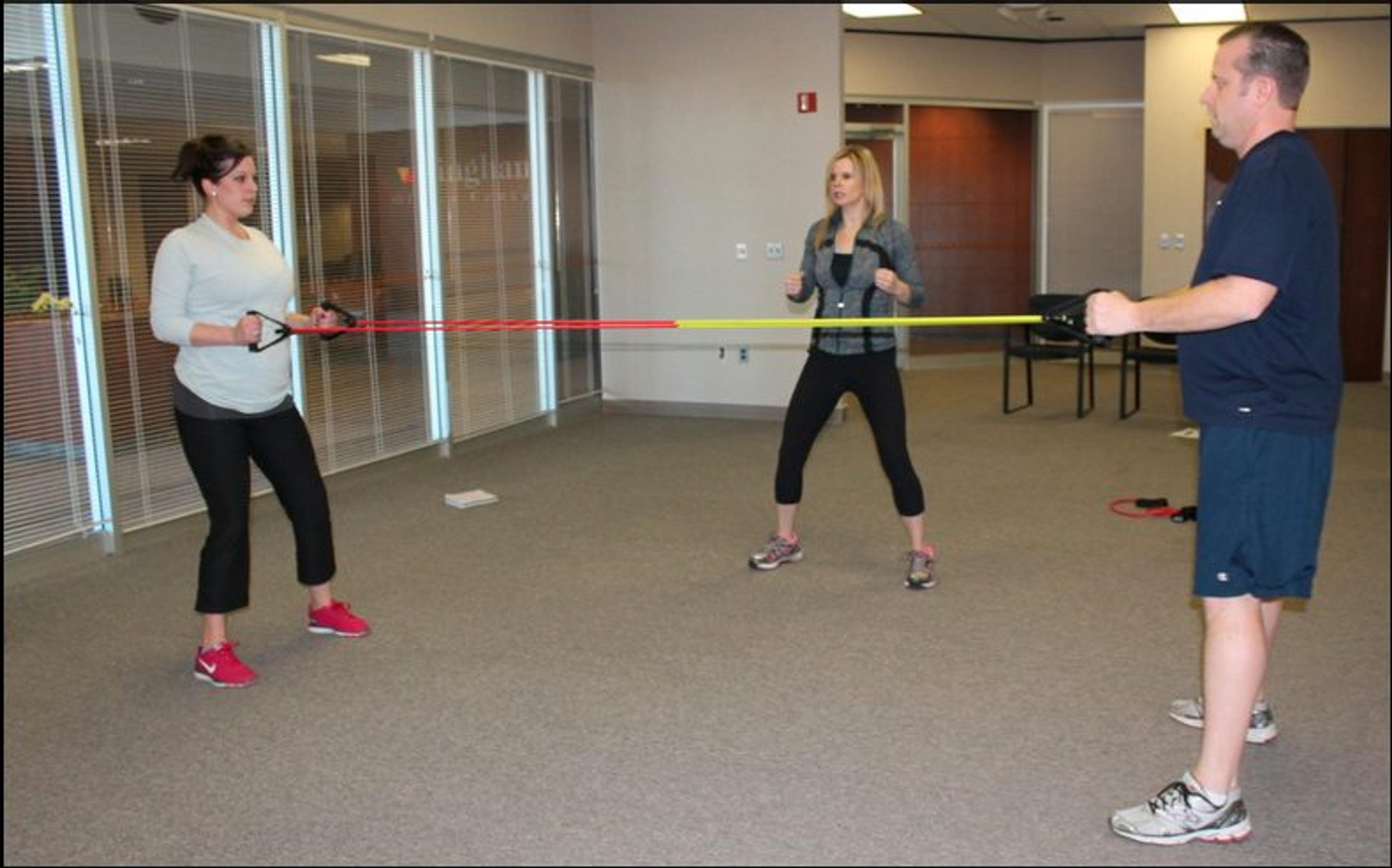Jennifer Cooper, trainer and owner of Healthy 4 Life, focuses on movements that target multiple muscle groups during Farbman Group's fitness program at Bingham Center in Bingham Farms, MI. 