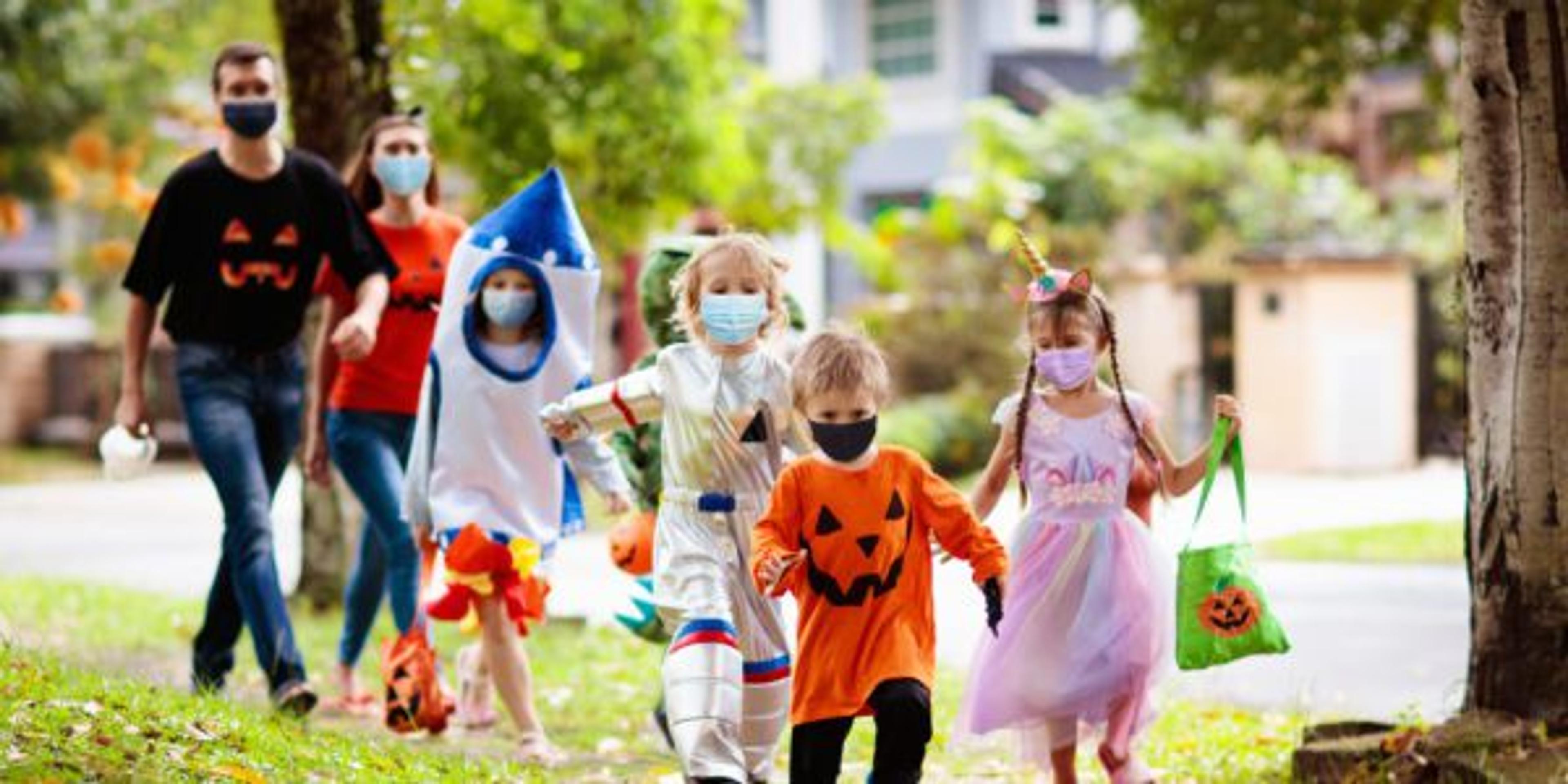 Kids trick or treat. Halloween in face mask.