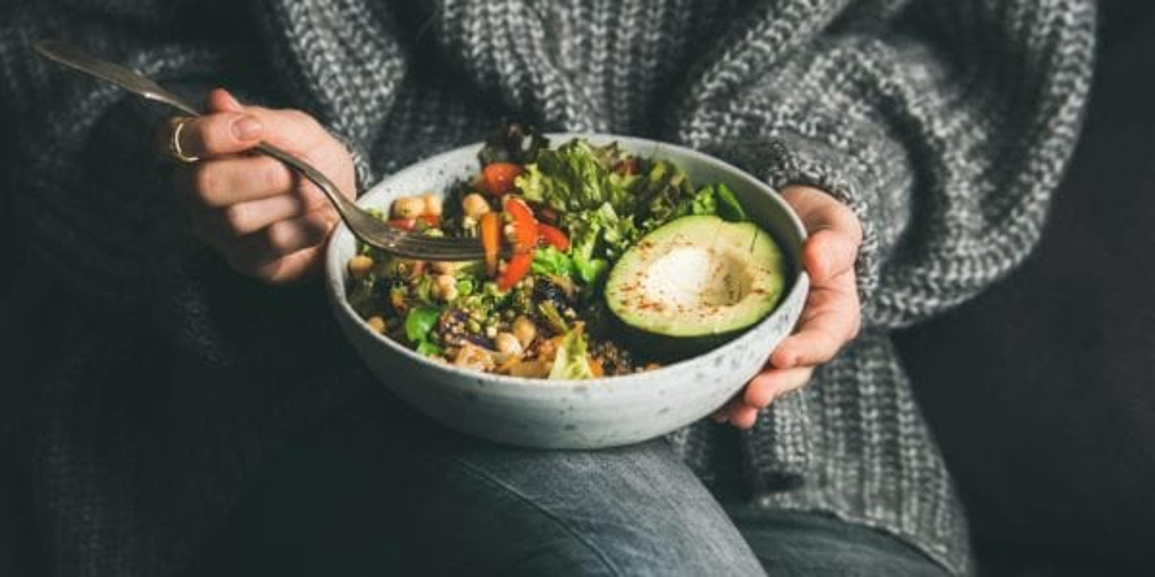 Girl holding avocado salad