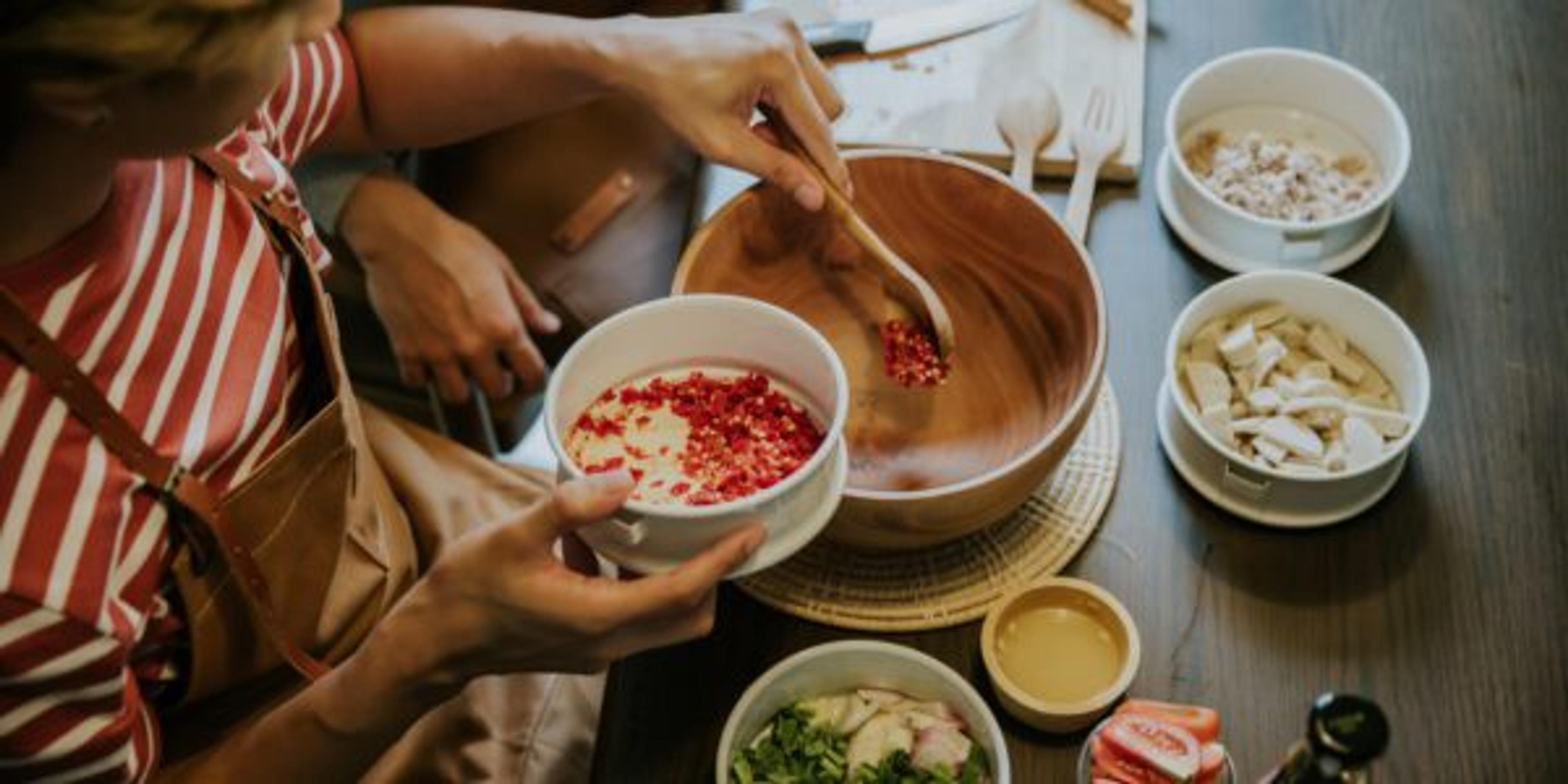 Weekend activity of asian gay couple cooking Thai salad for lunch together.