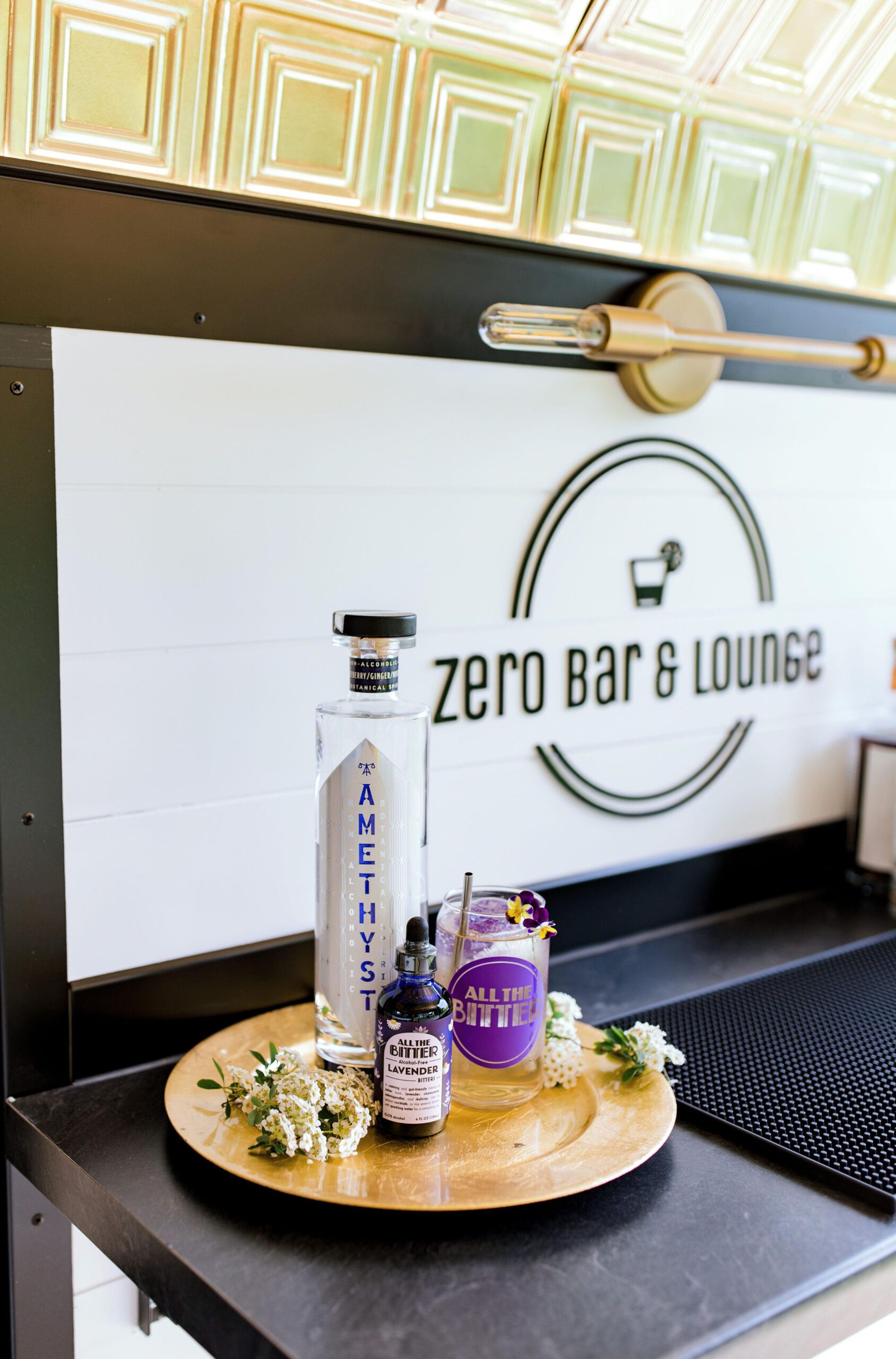 Spirits and bitters used at Zero Bar & Lounge are photographed in front of the company trailer.