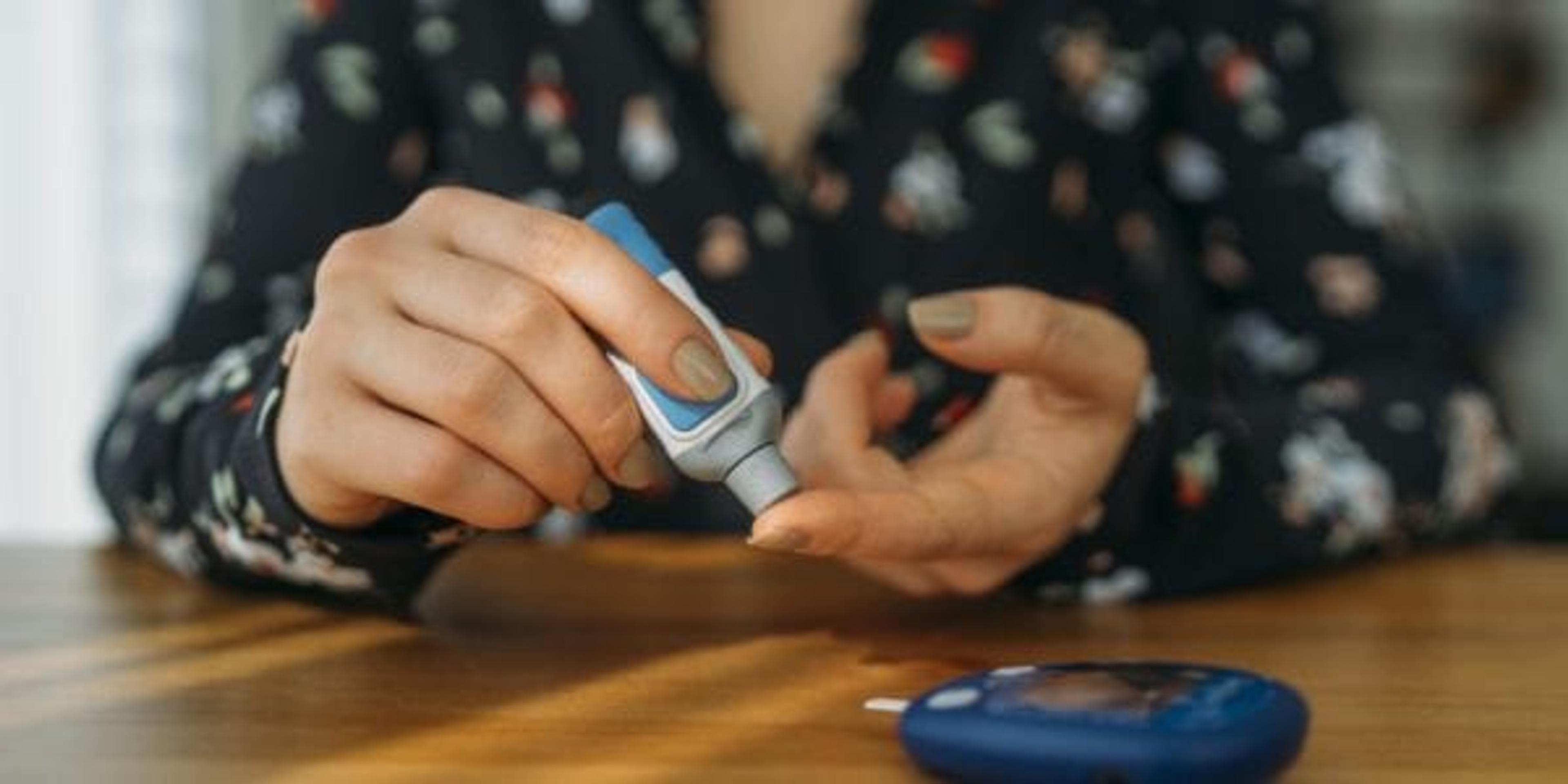 Woman testing her blood sugar