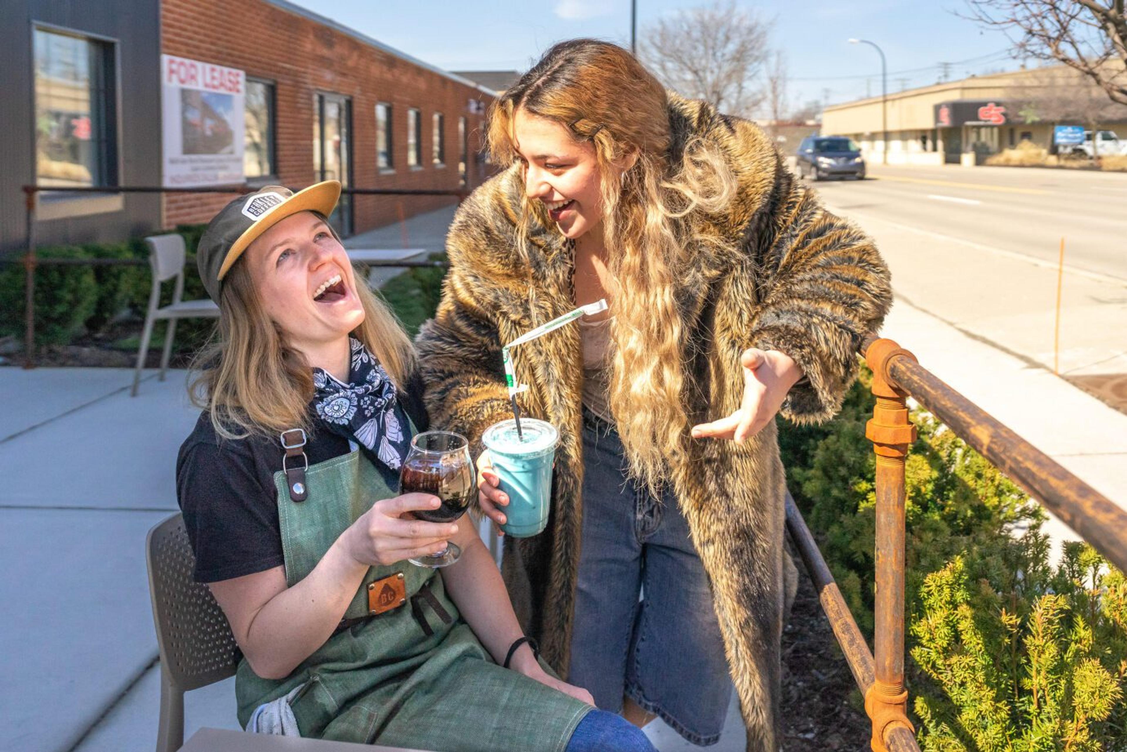 Oak Park Dry employees share a laugh behind the store.