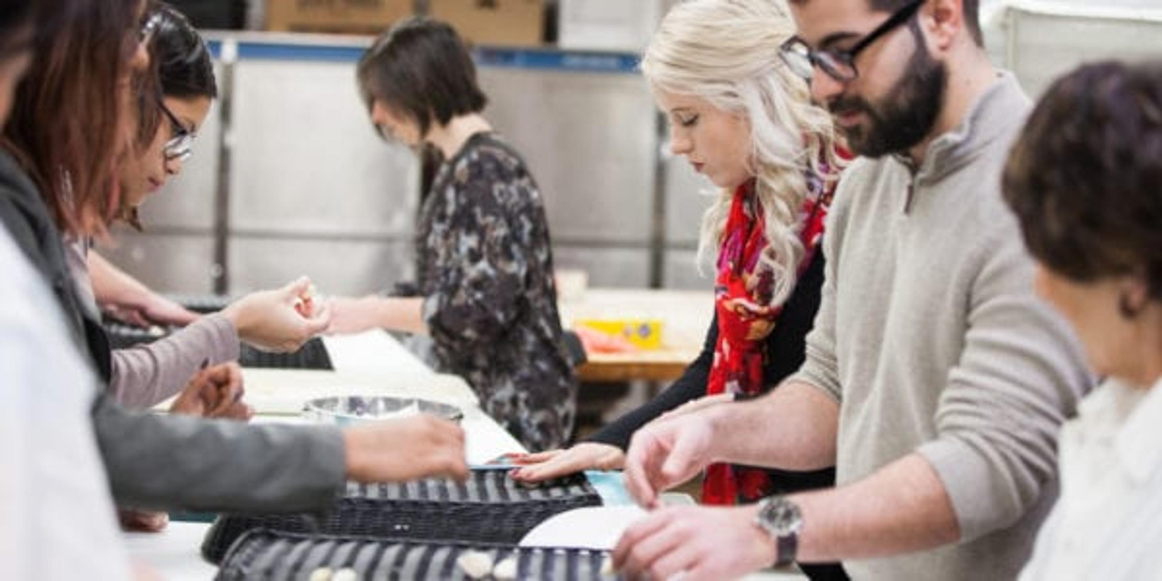 man and a woman rolling gnocchi