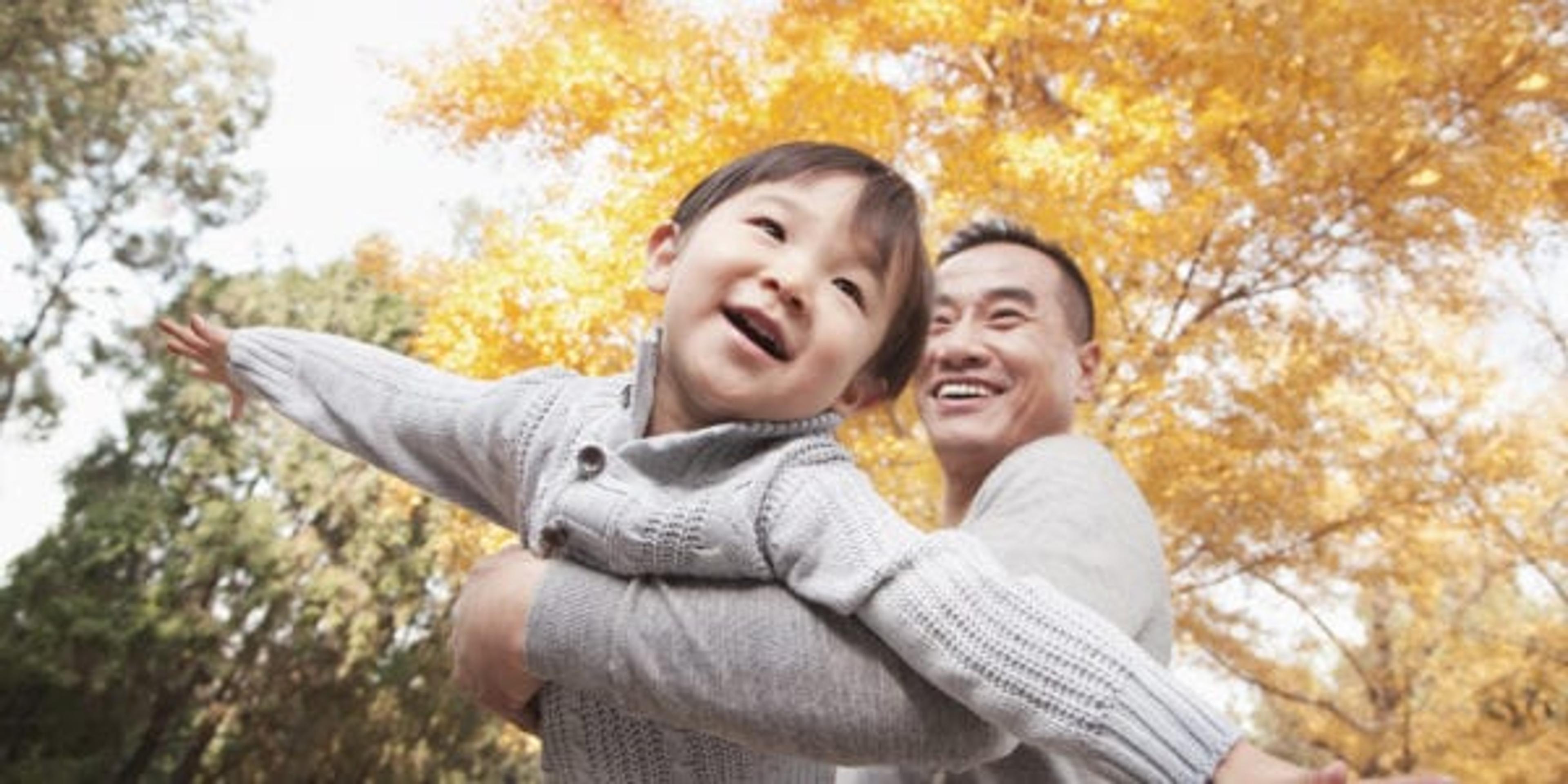 Father and Son Playing at Park in Autumn