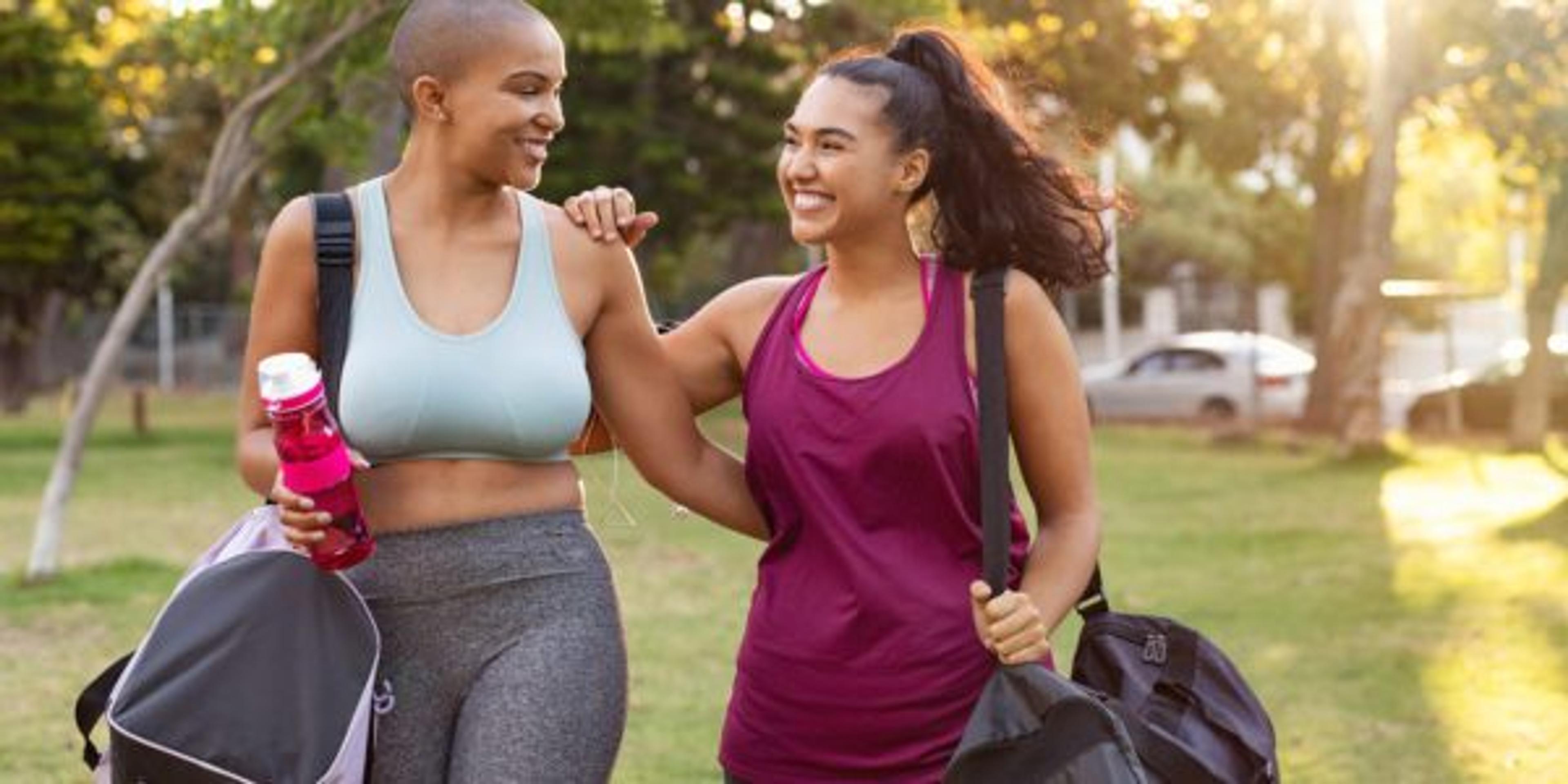 Curvy friends walking home after fitness exercise