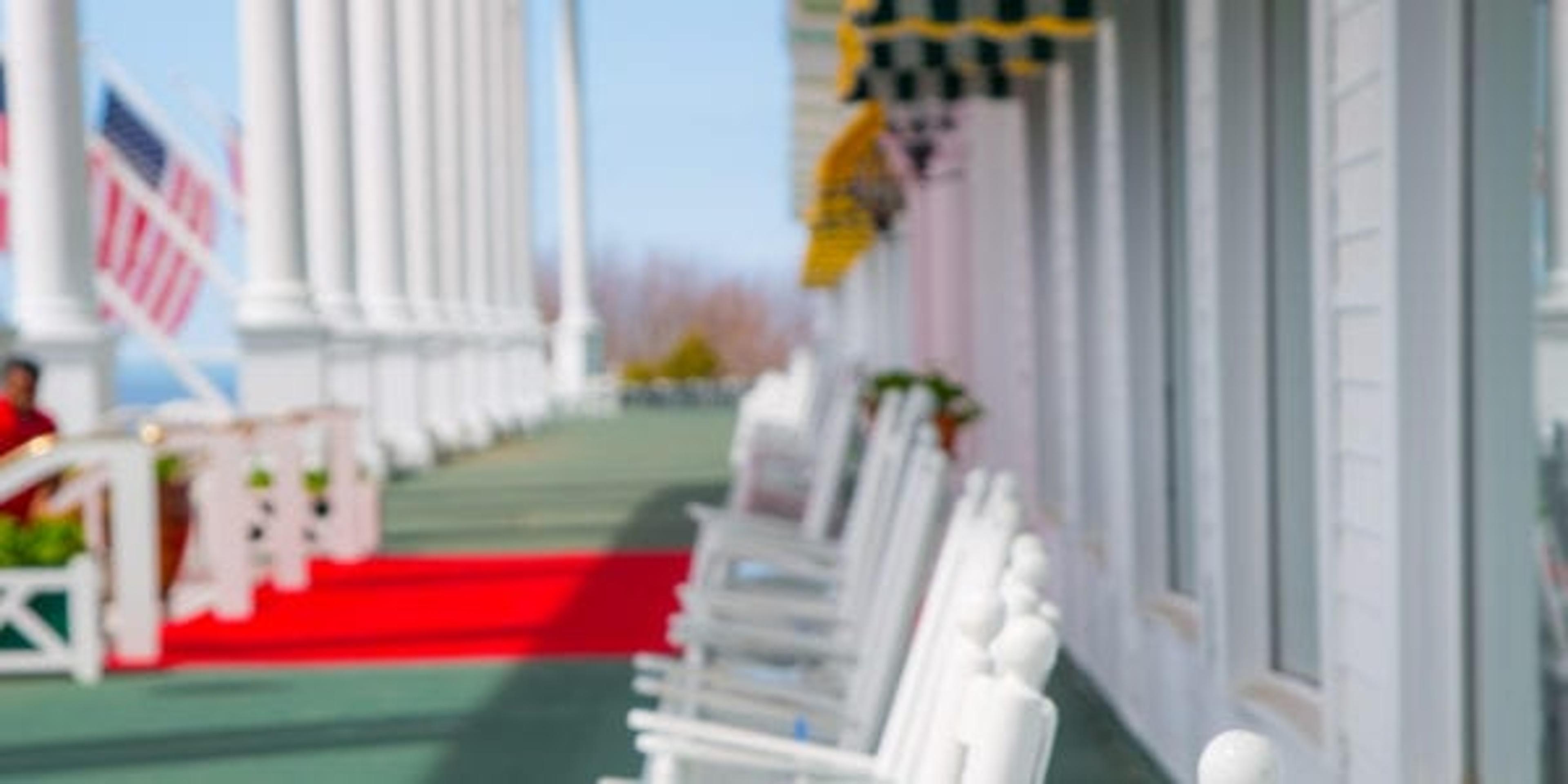 white rocking chairs on a sea foam green deck