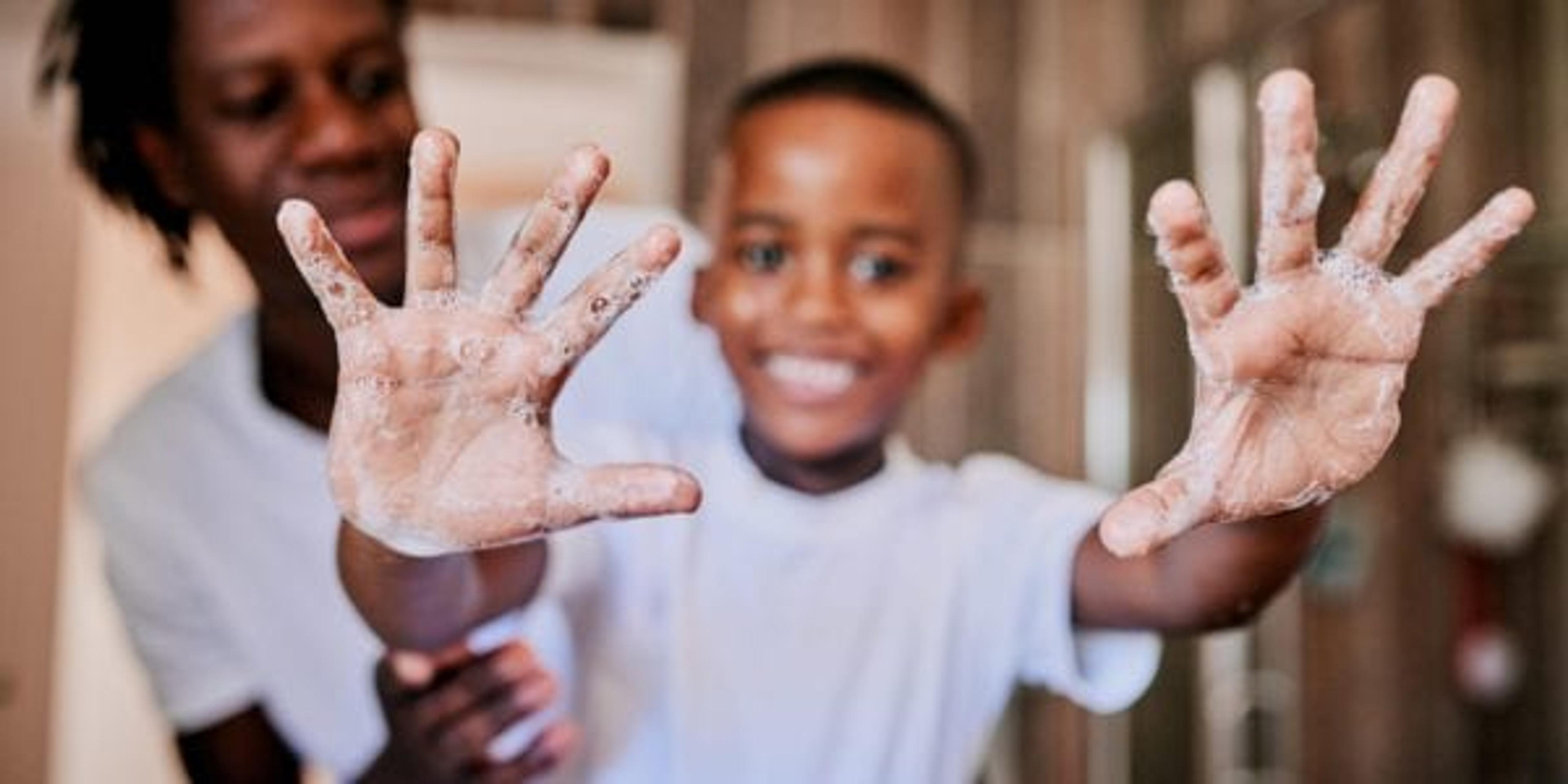 Little boy showing off his handwashing technique