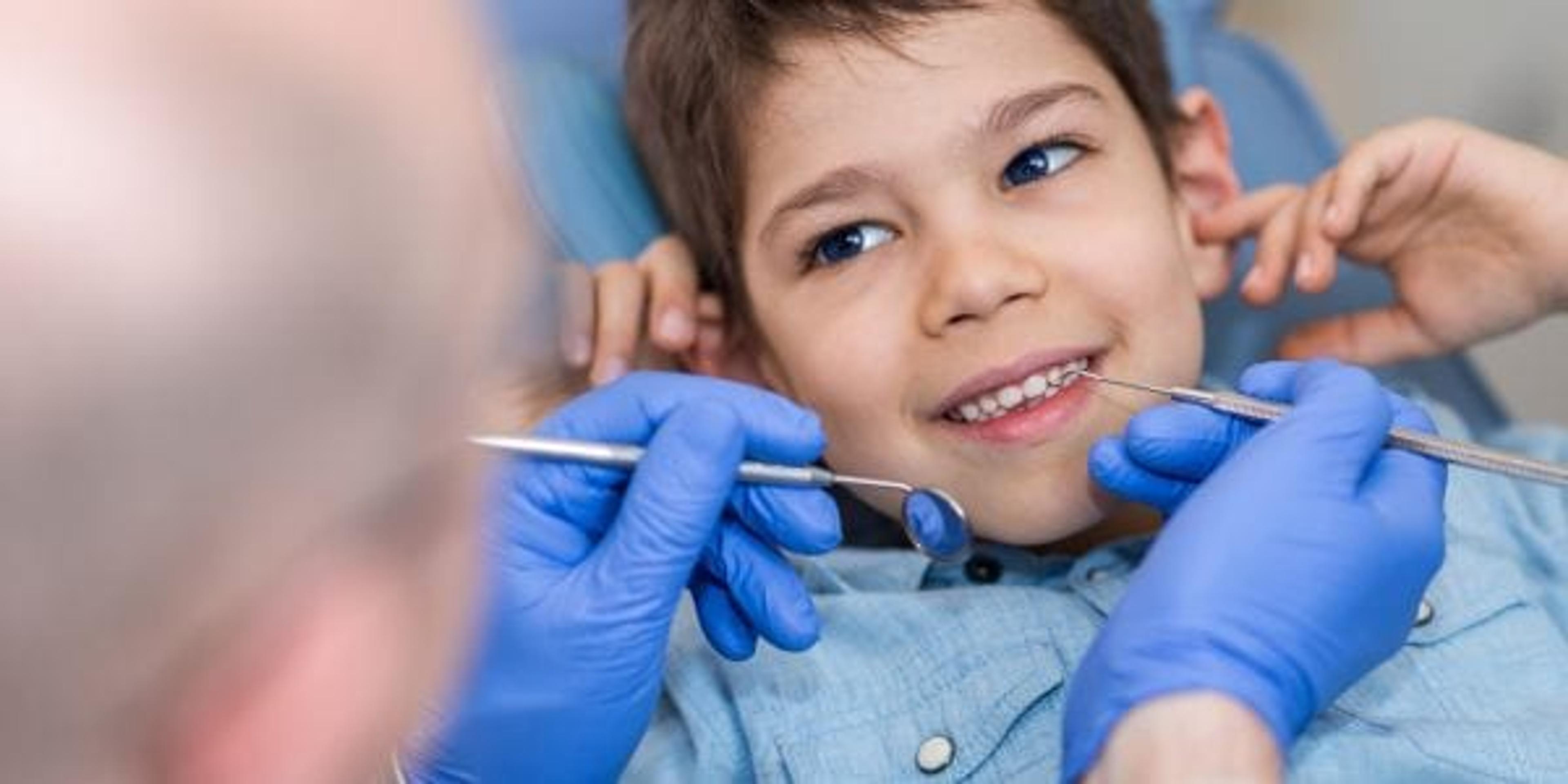 Young boy in dentist chair smiling