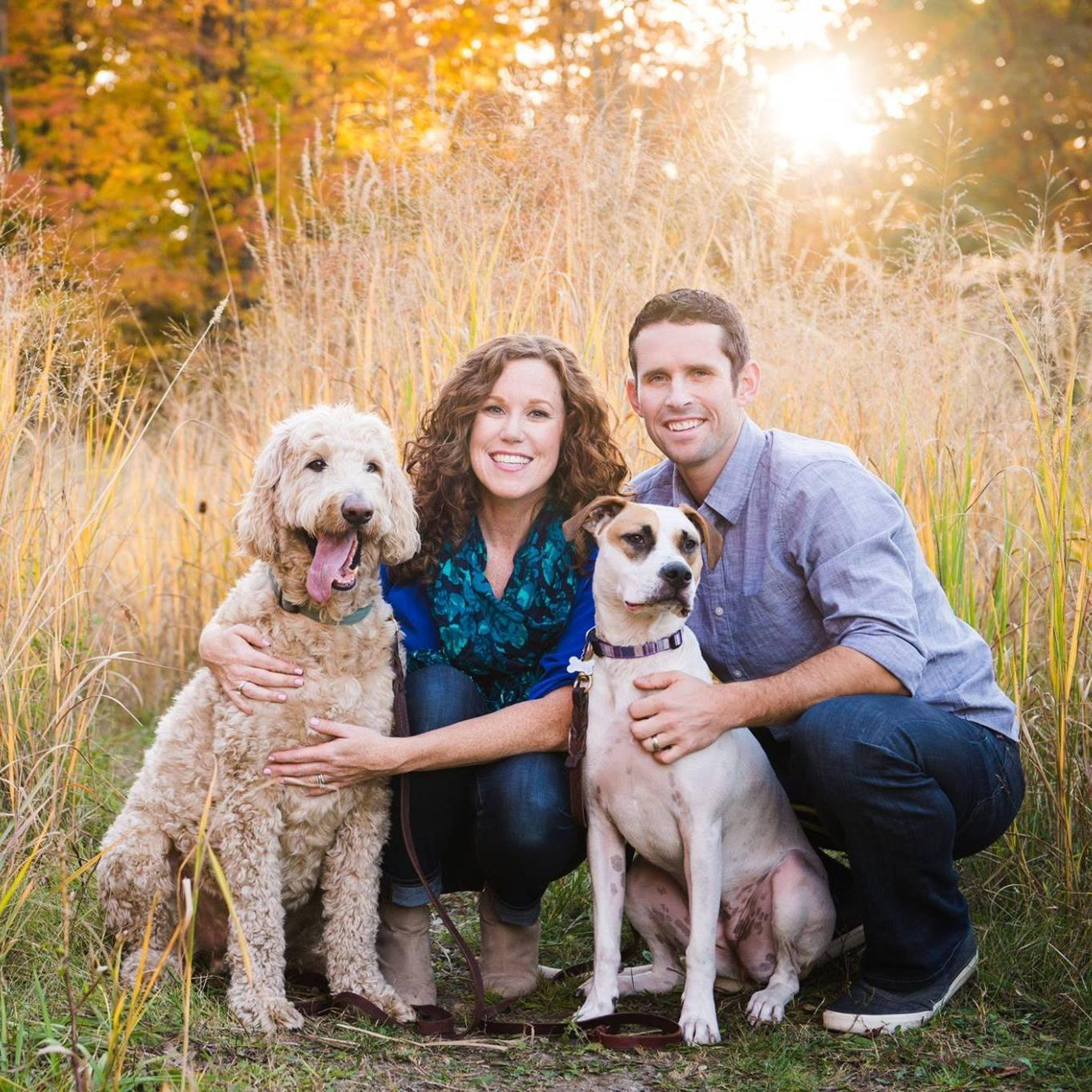 Meghan with her husband and two dogs