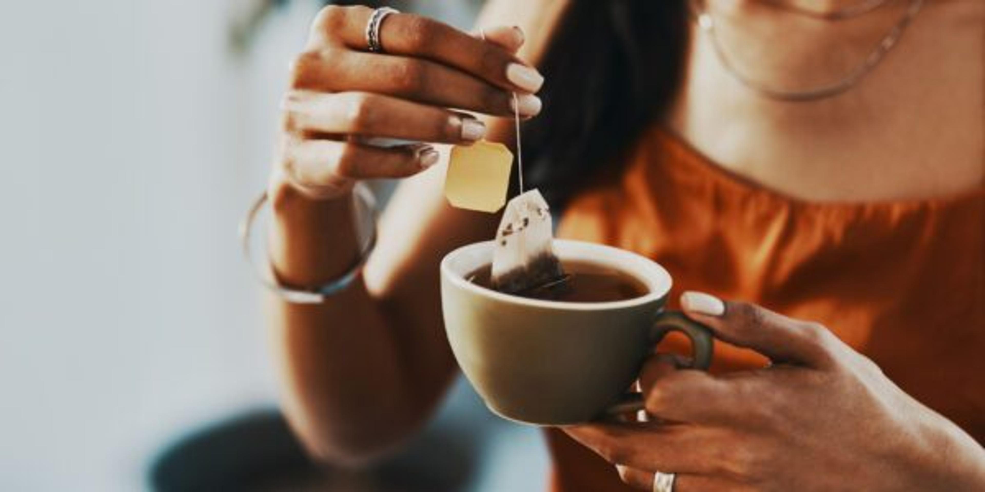 Woman enjoying health benefits of tea during a tea break