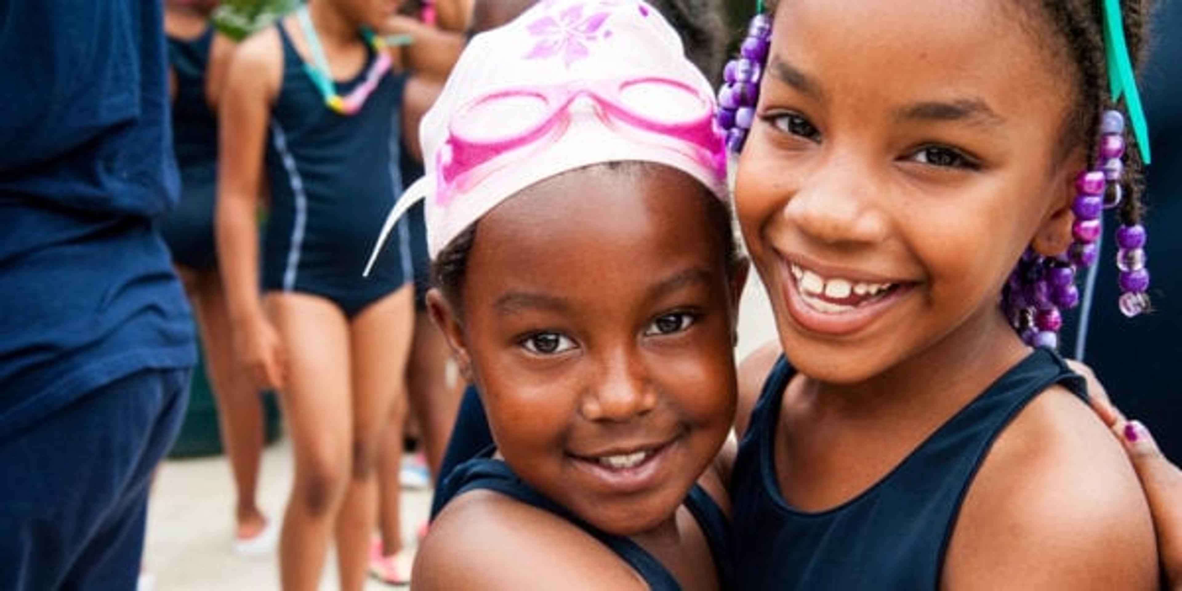 Two young girls getting ready for swimming lessons