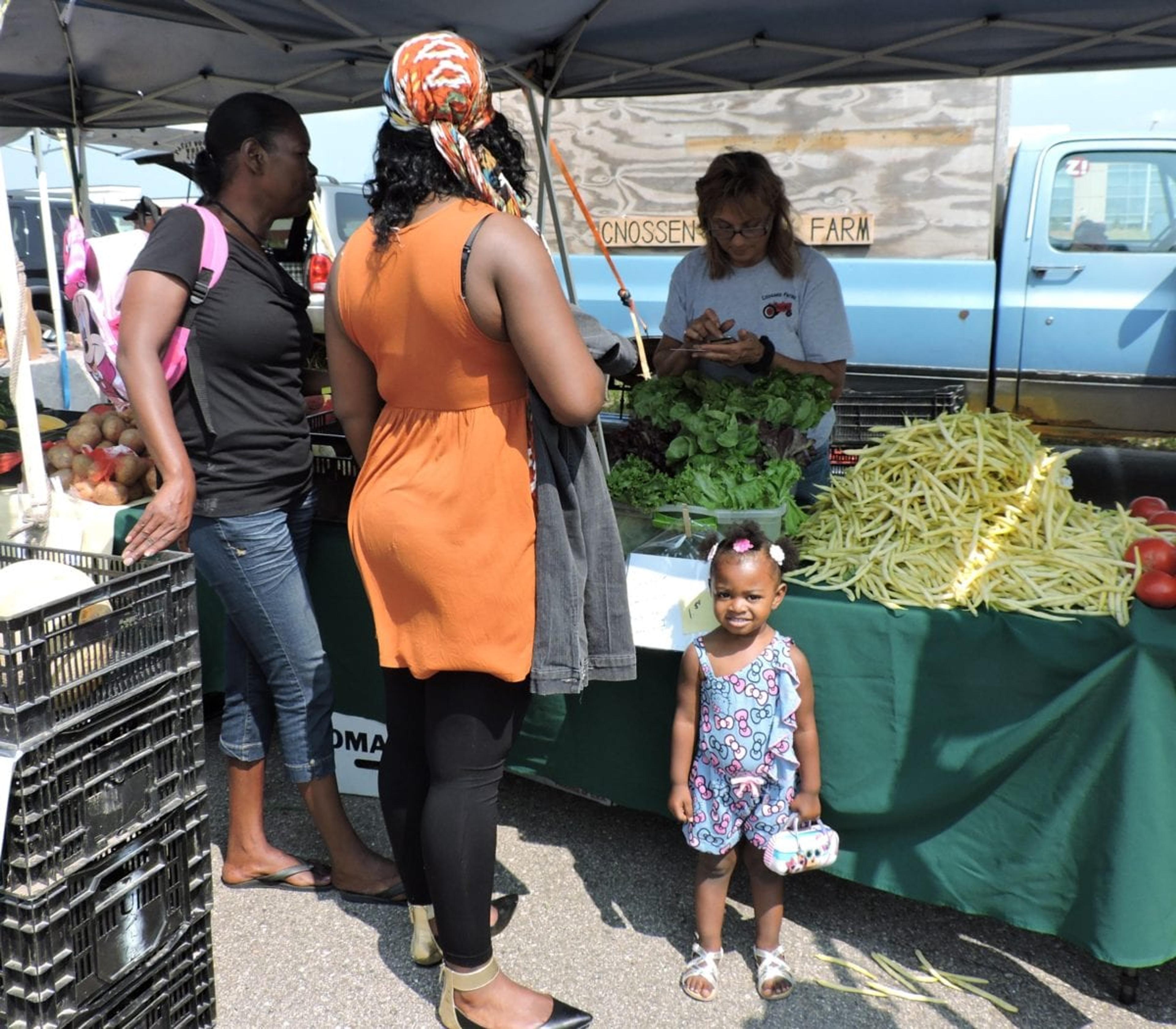 Shoppers loading up on healthy fare at Metro Health's farmers market. 