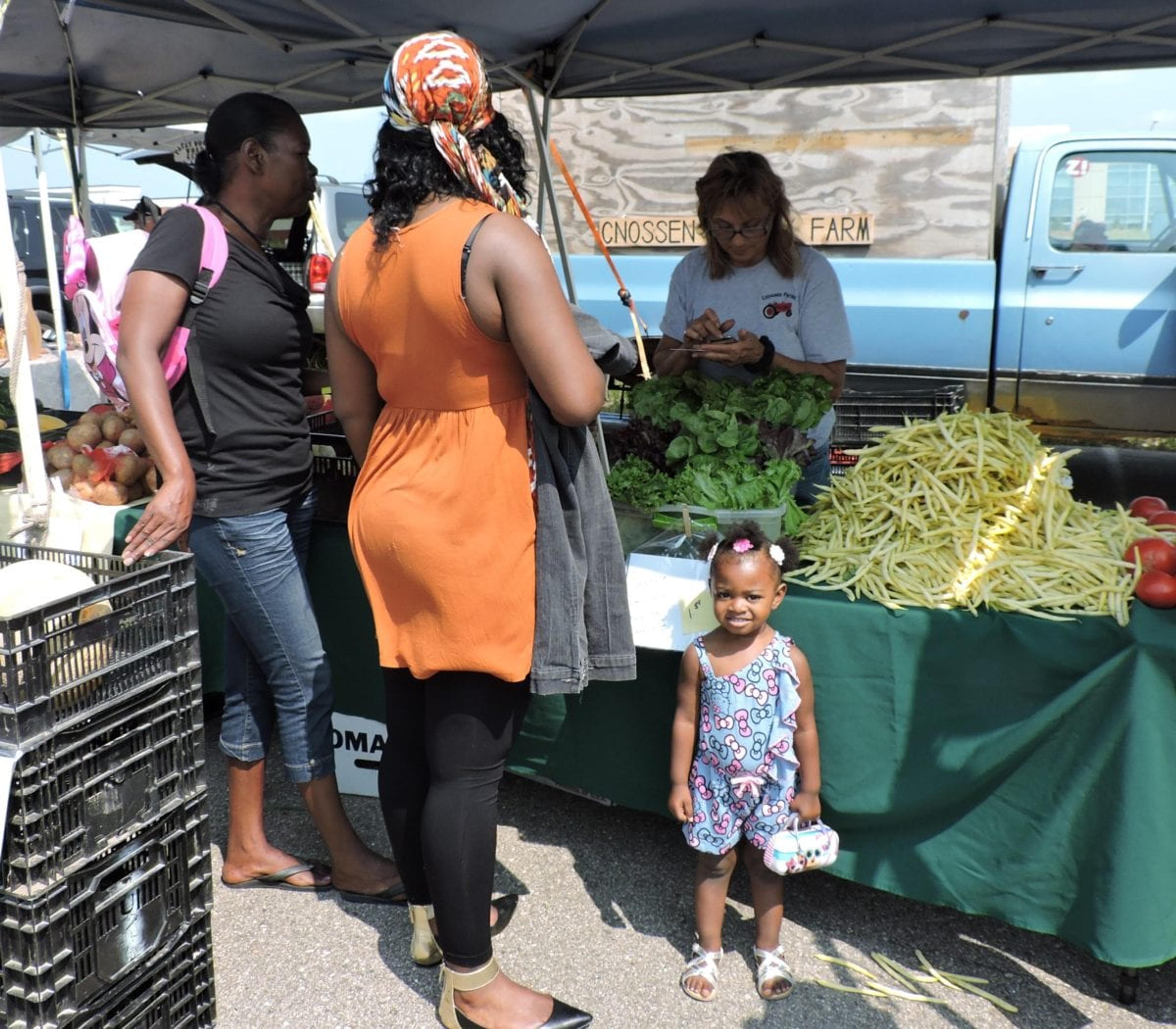 Shoppers loading up on healthy fare at Metro Health's farmers market.