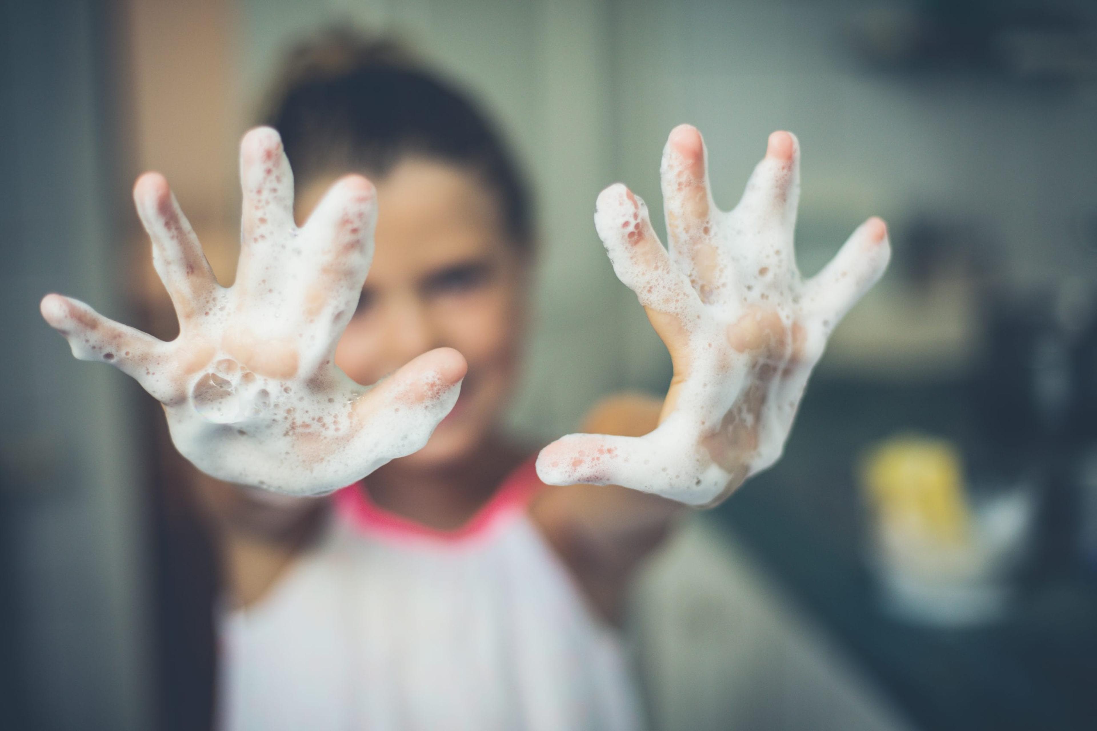 Young girl washing her hands