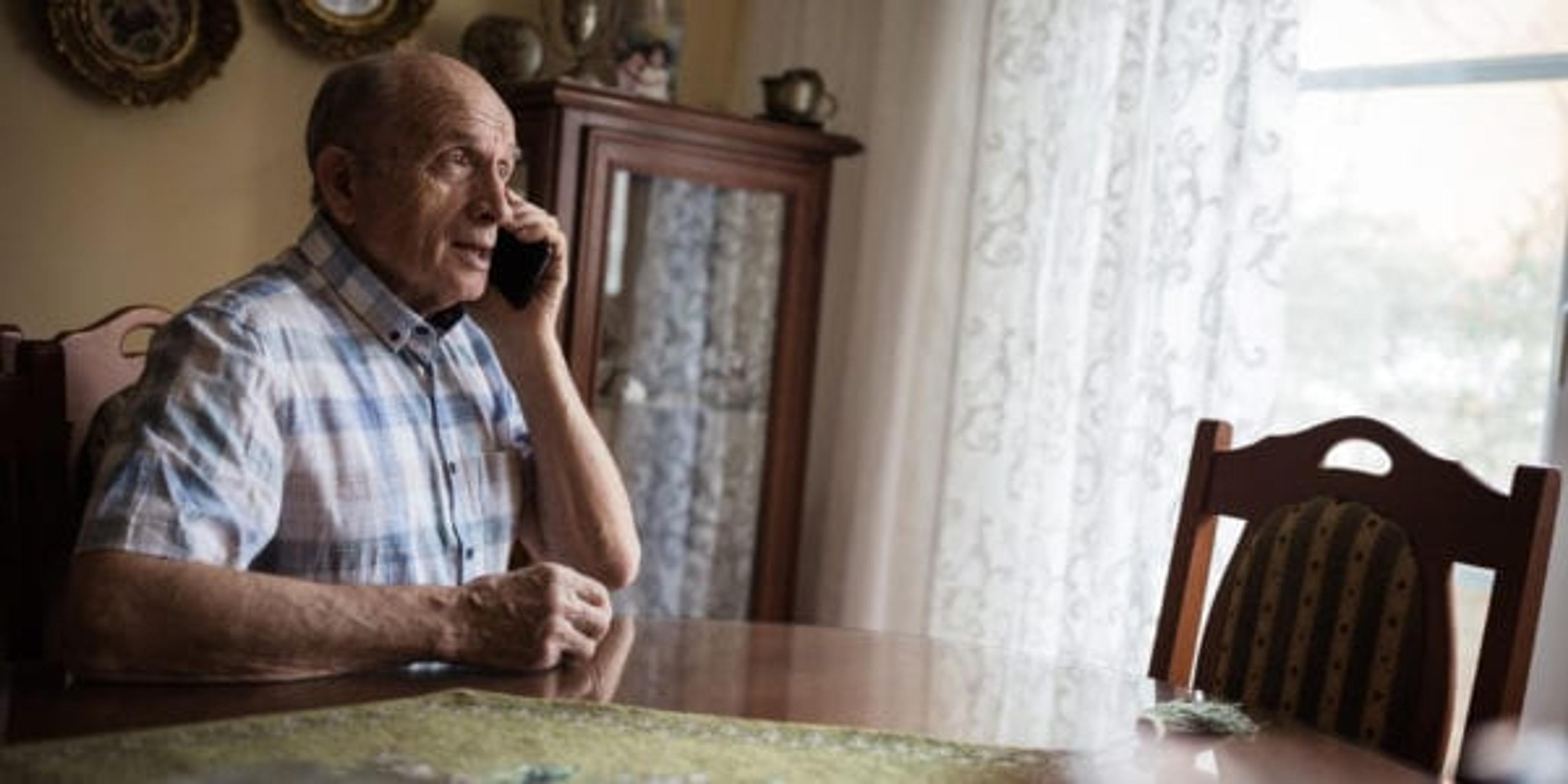 Elderly man talking on the phone