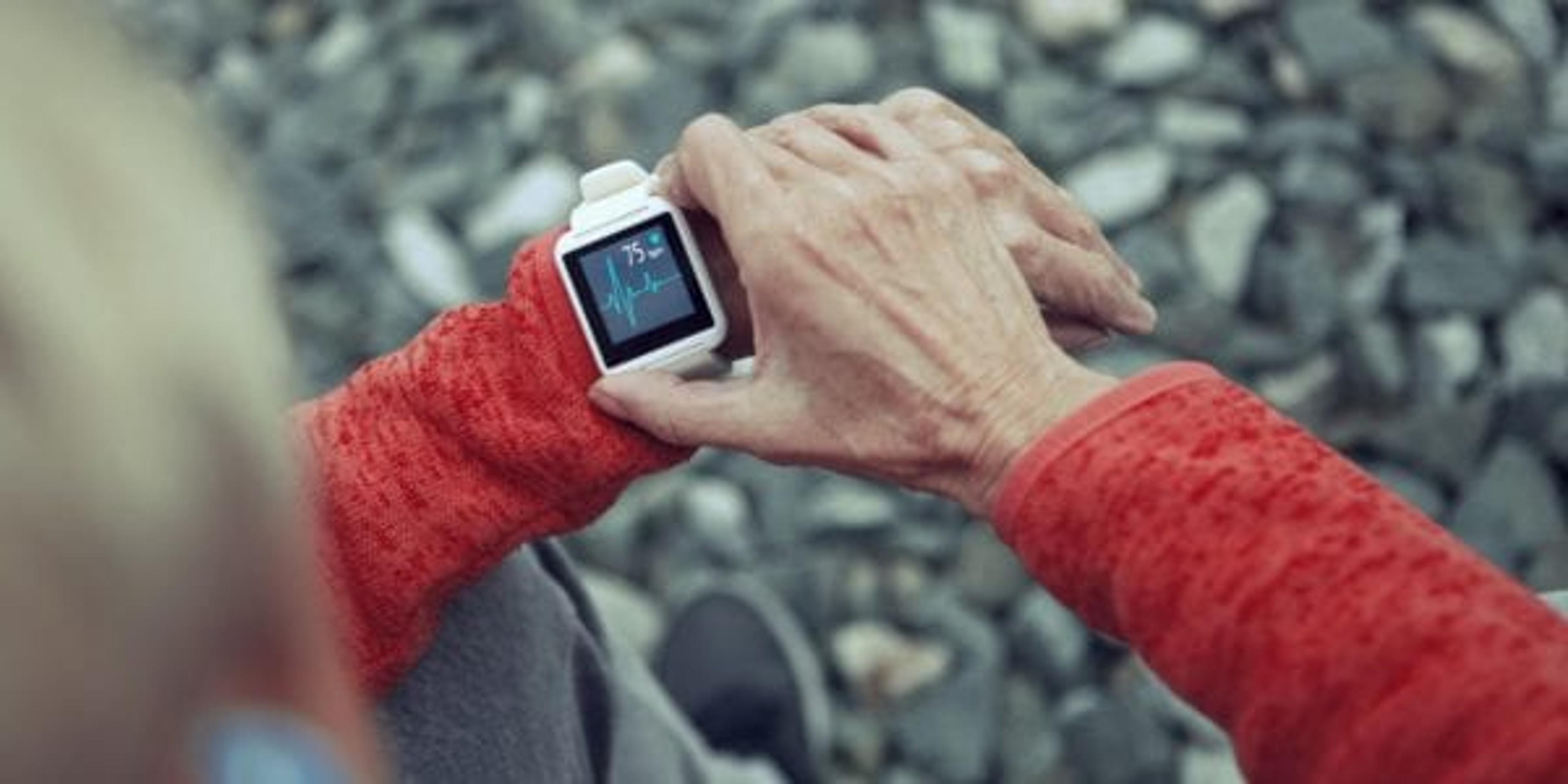 Woman checks her smart watch