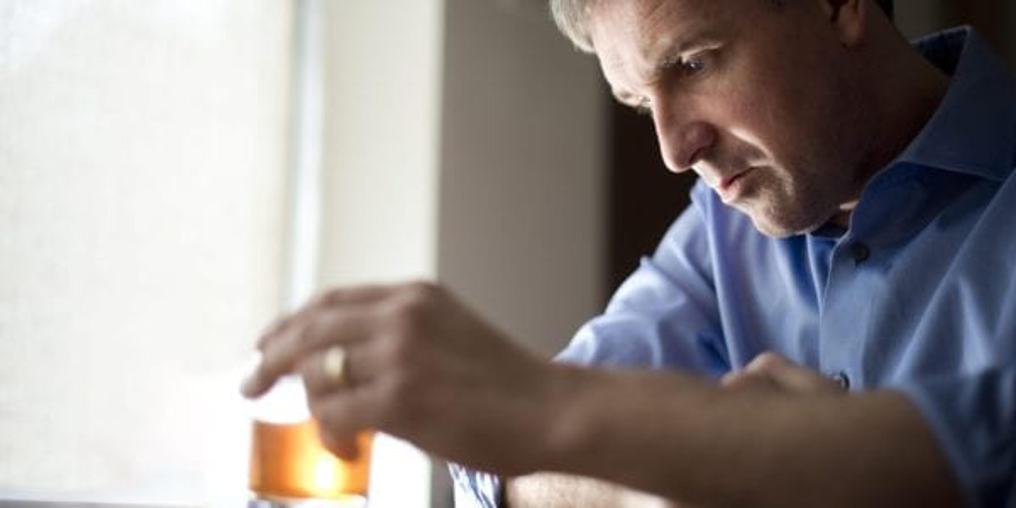 Man drinking alone at home