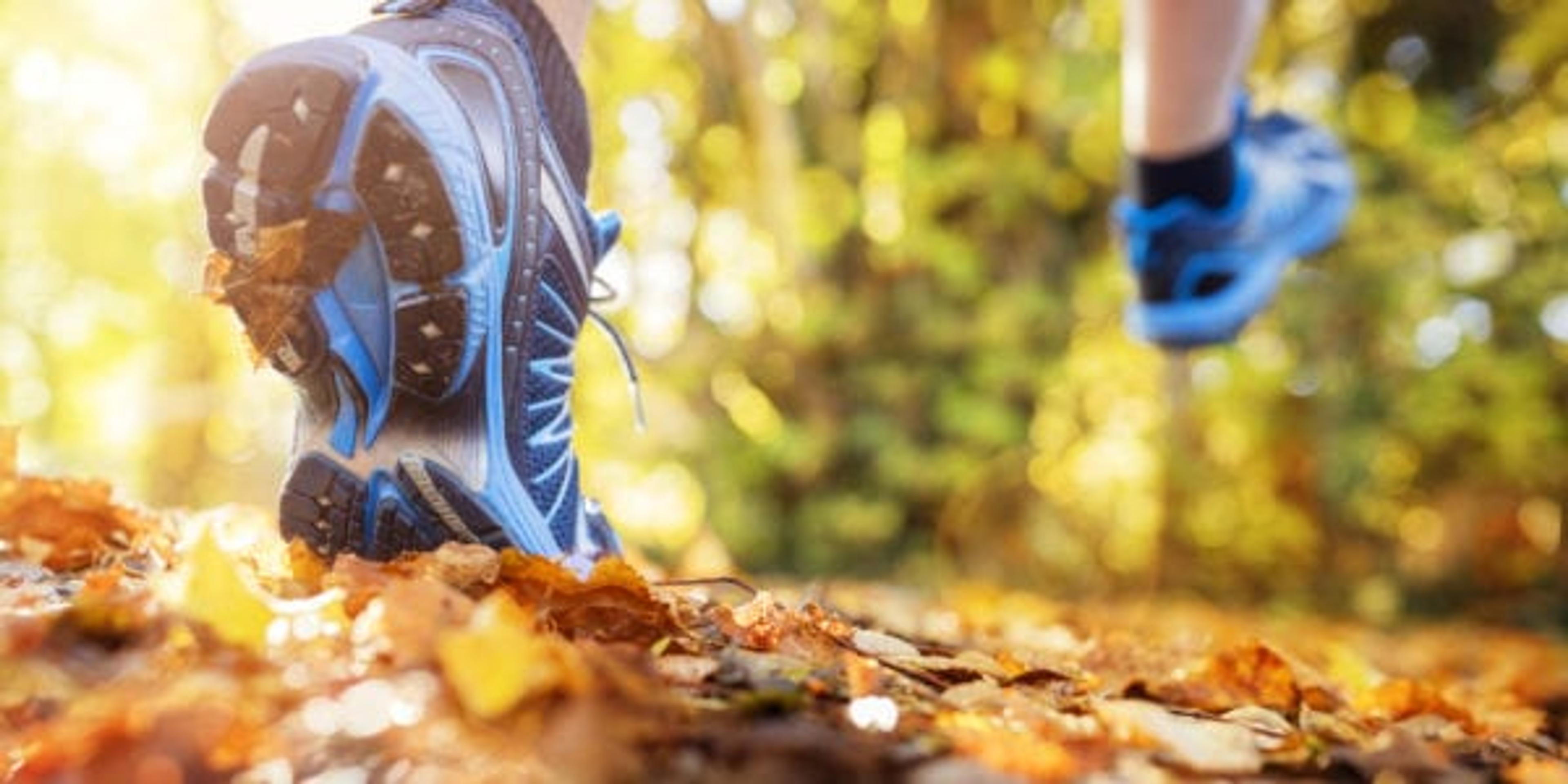Image of a runner crunching through fall leaves.
