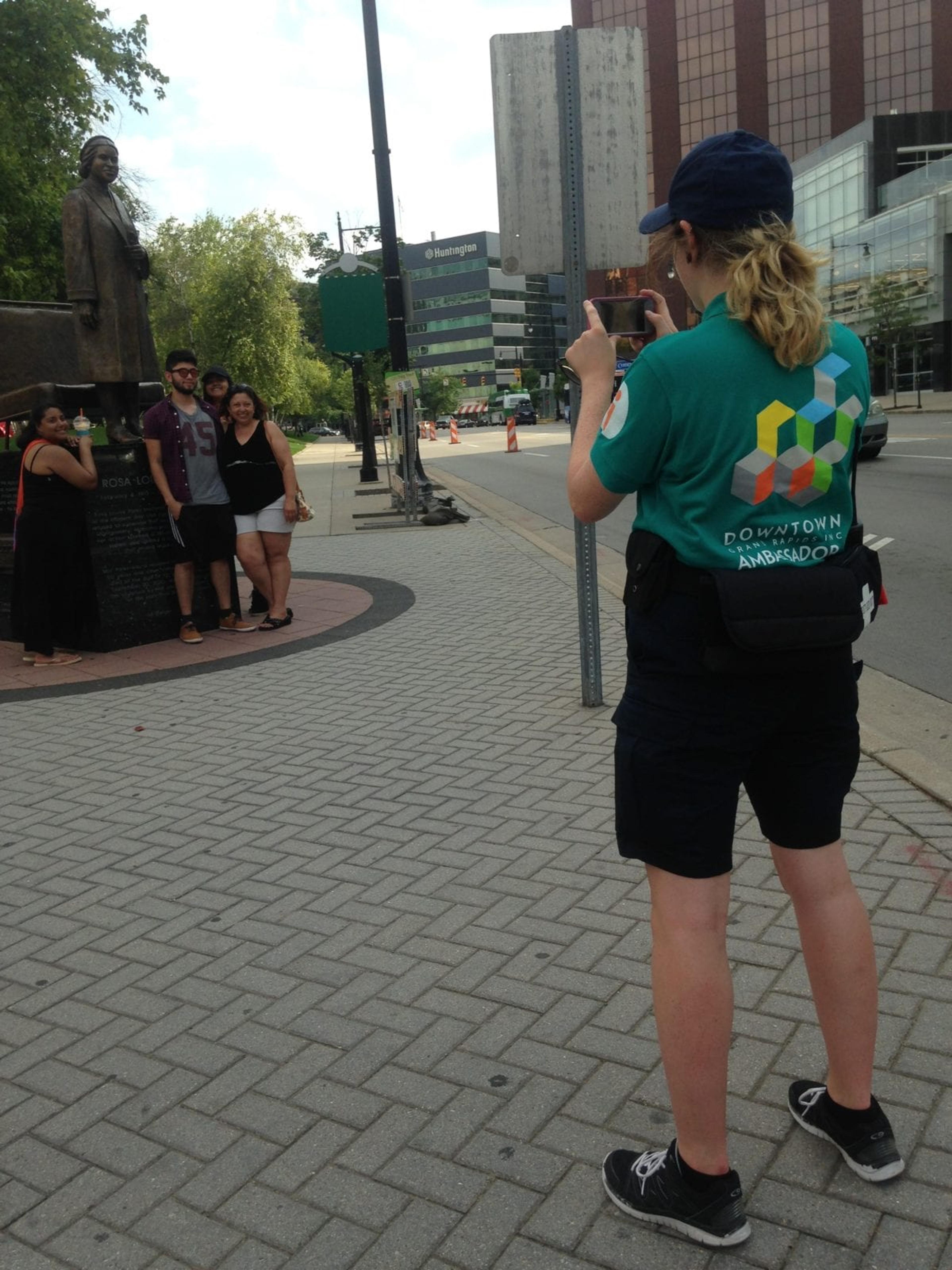 A Grand Rapids ambassador stops to take a picture for visitors to downtown.