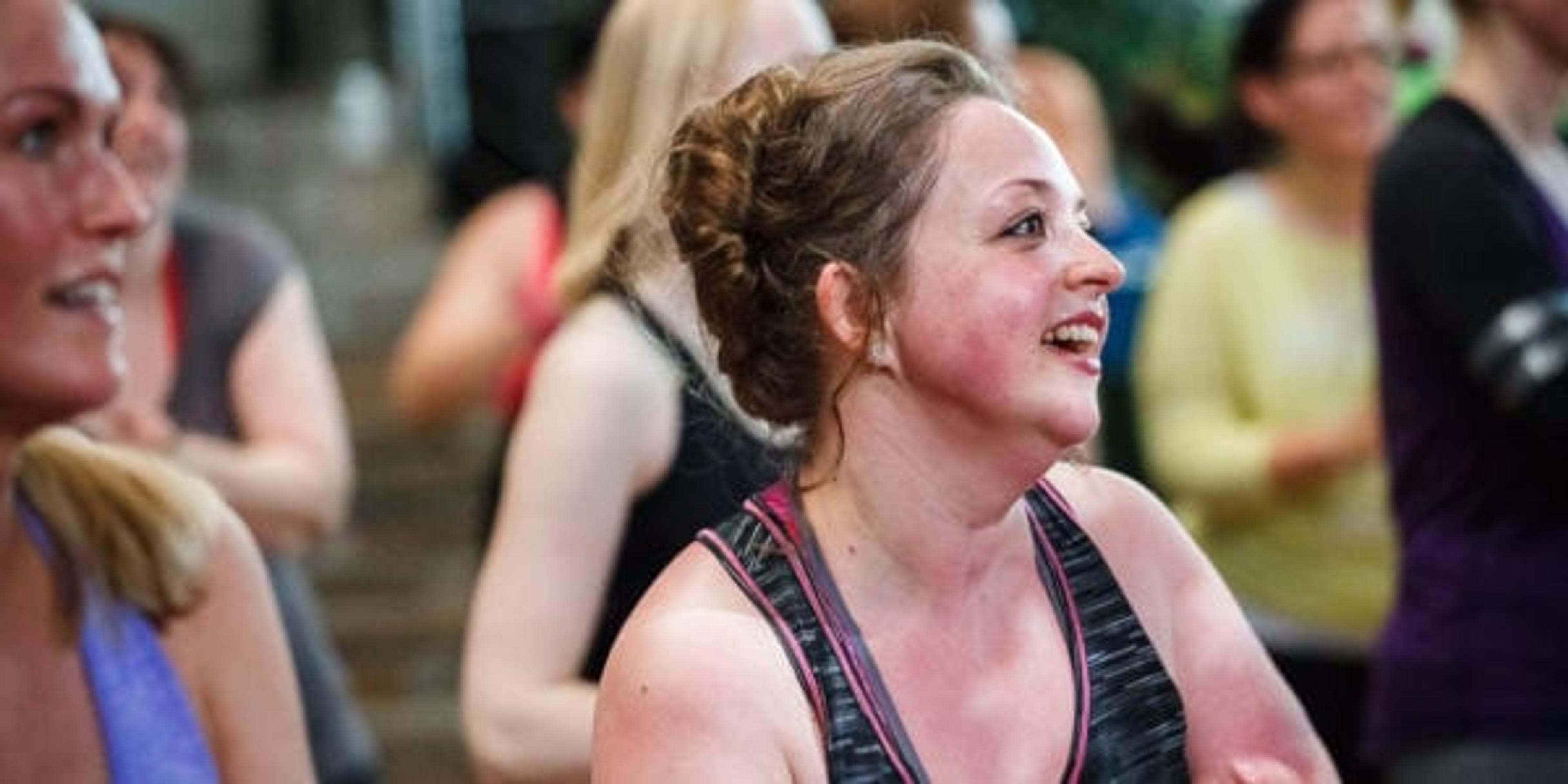 Woman working out in a Zumba class.