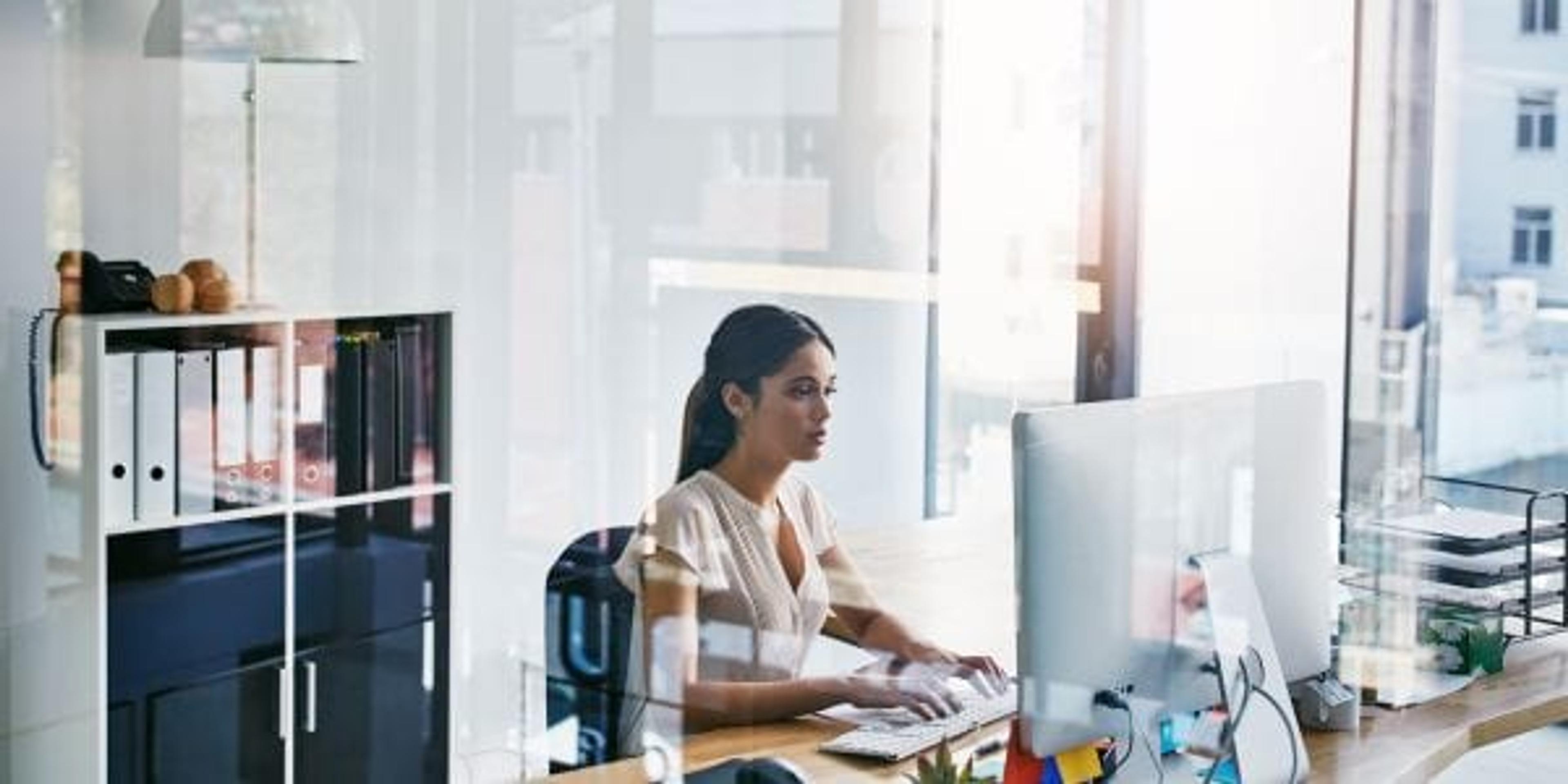 Cropped shot of an attractive businesswoman working on her computer at her desk