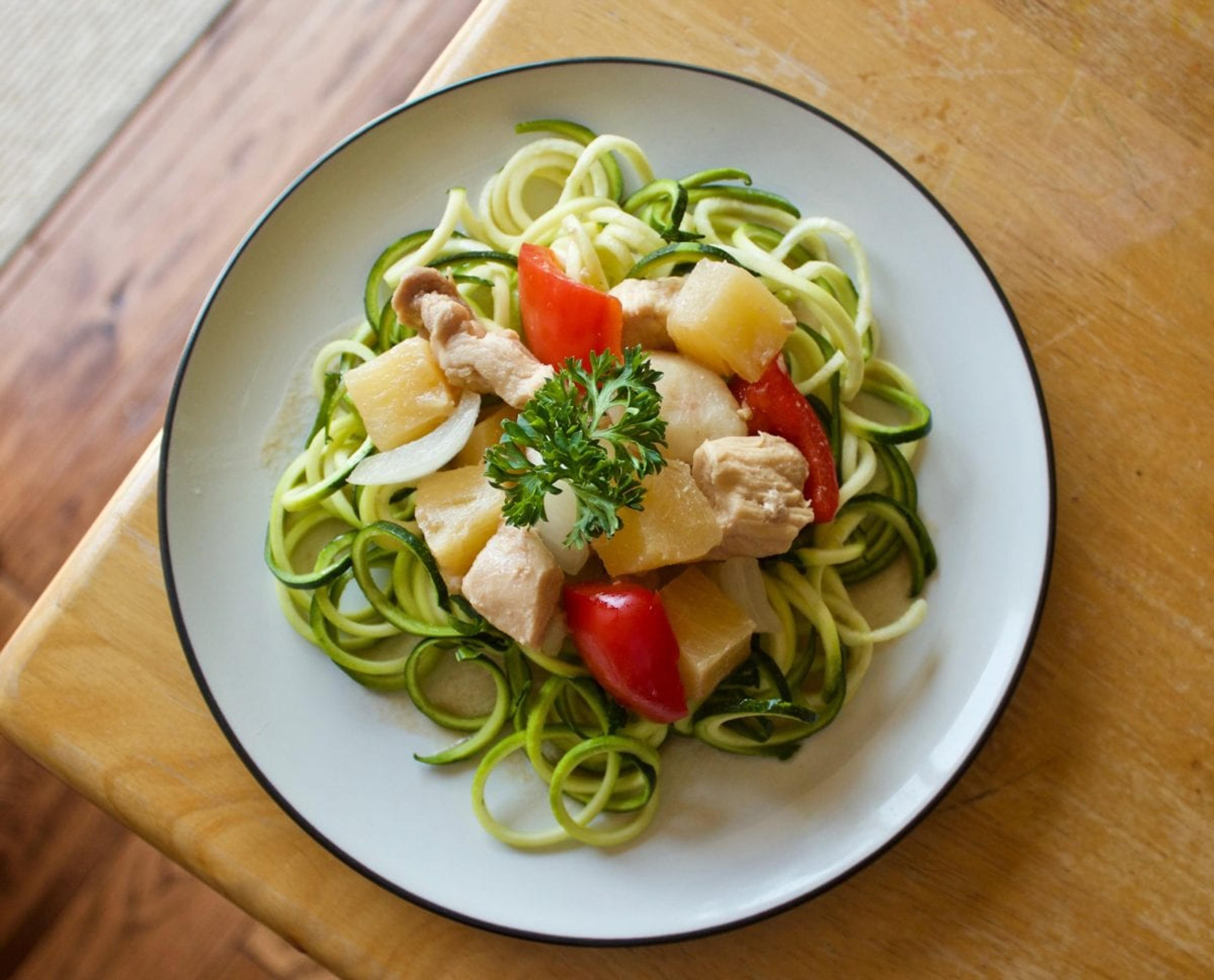 Complete dish of zoodles arranged on a white plate