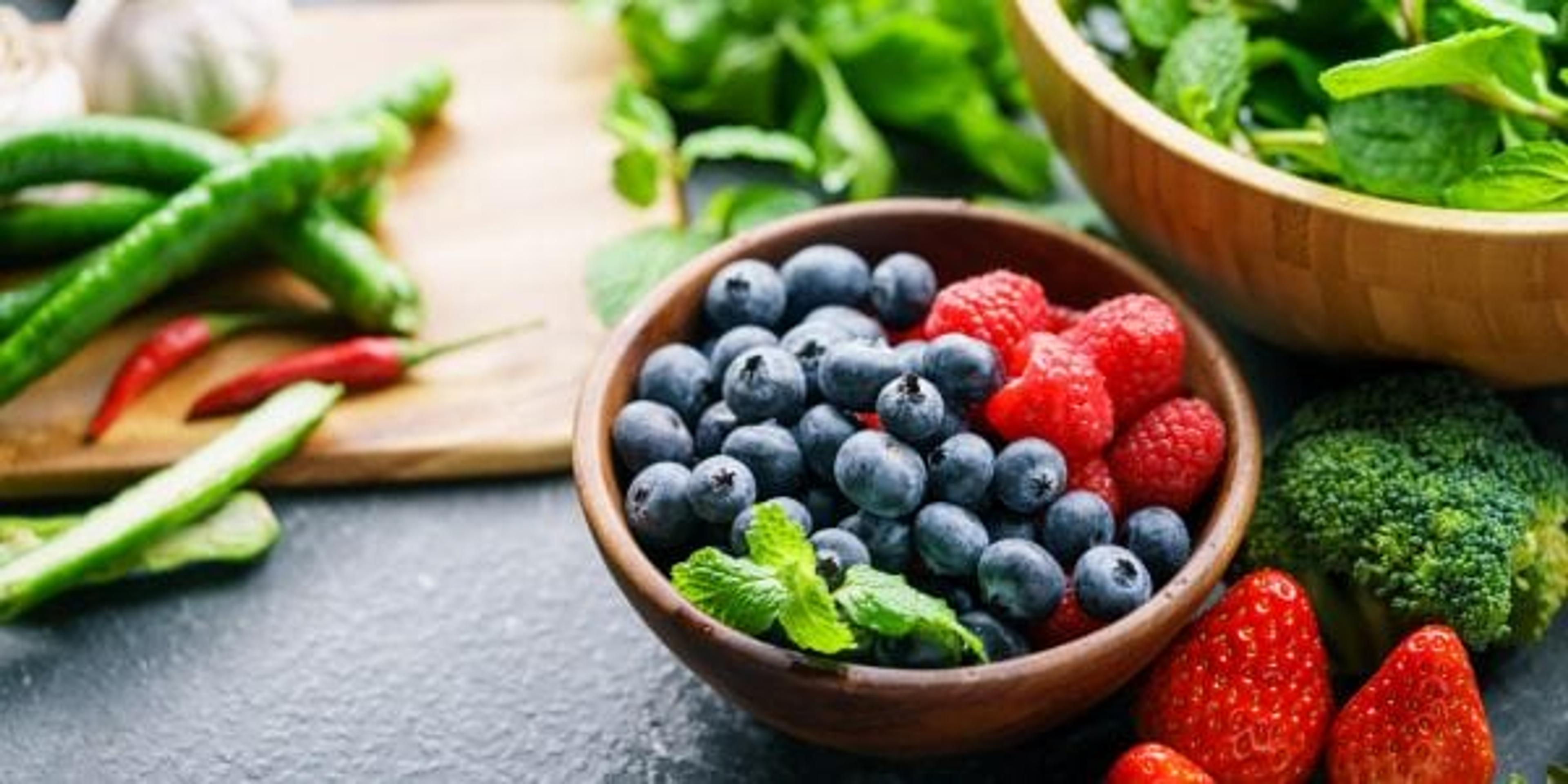 Antioxidant-rich berries surrounded by leafy greens and other veggies