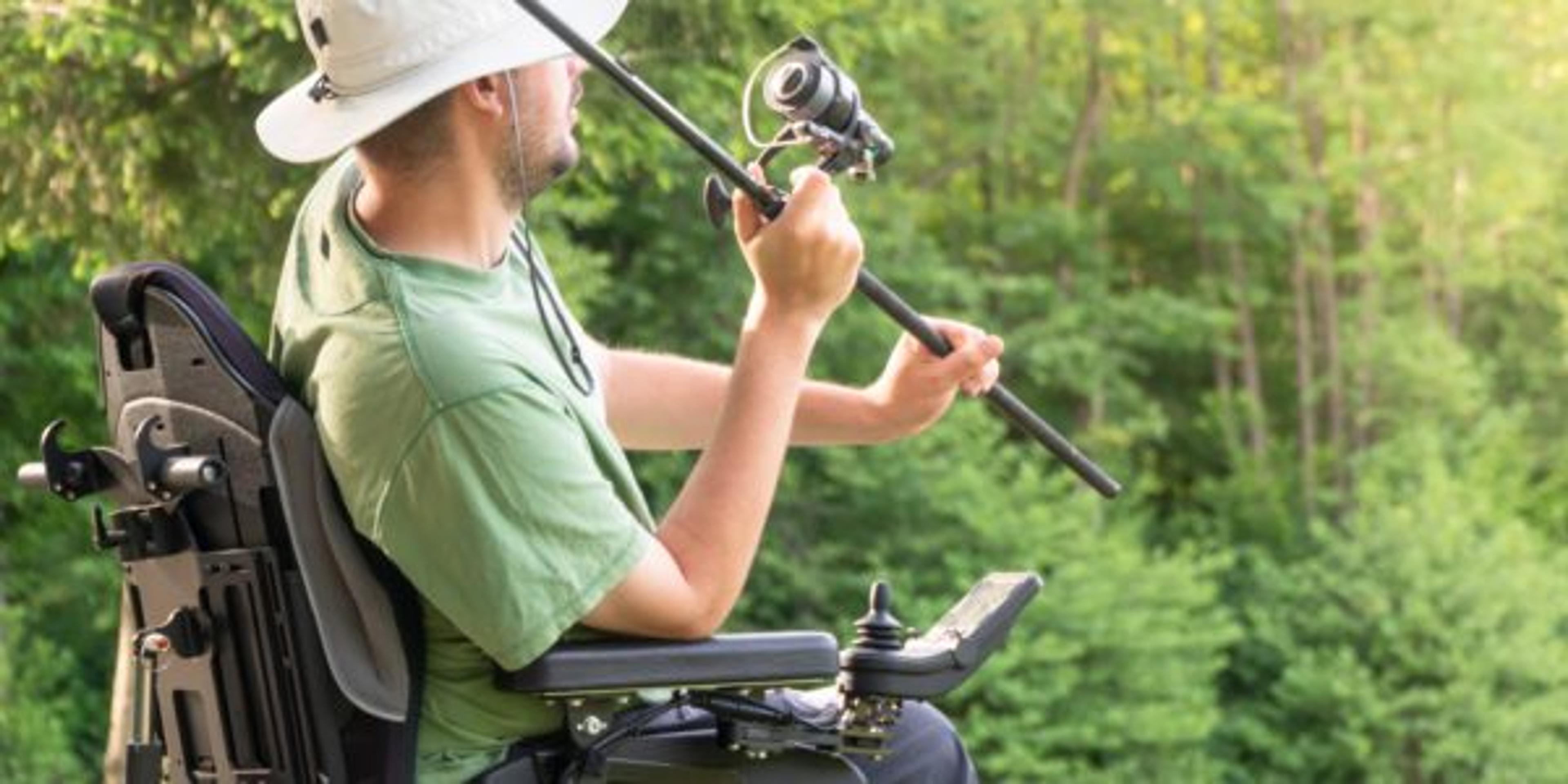 young man in a electric wheelchair fishing