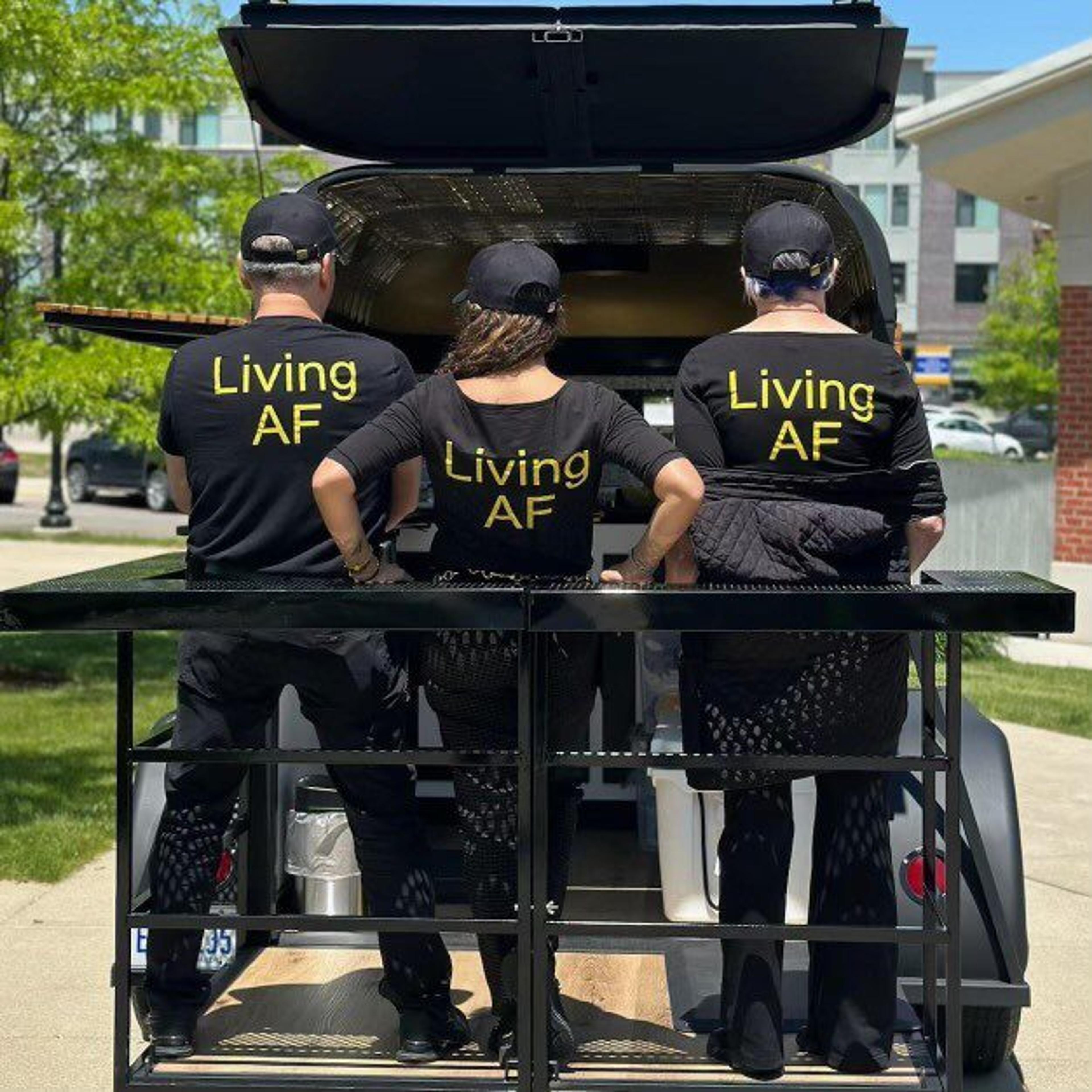 Josnelly Aponte-Martinez, Francisco Martinez and Sandy Yeager pose for a photo wearing T-shirts that read "Living AF," which stands for "Living Alcohol-Free."