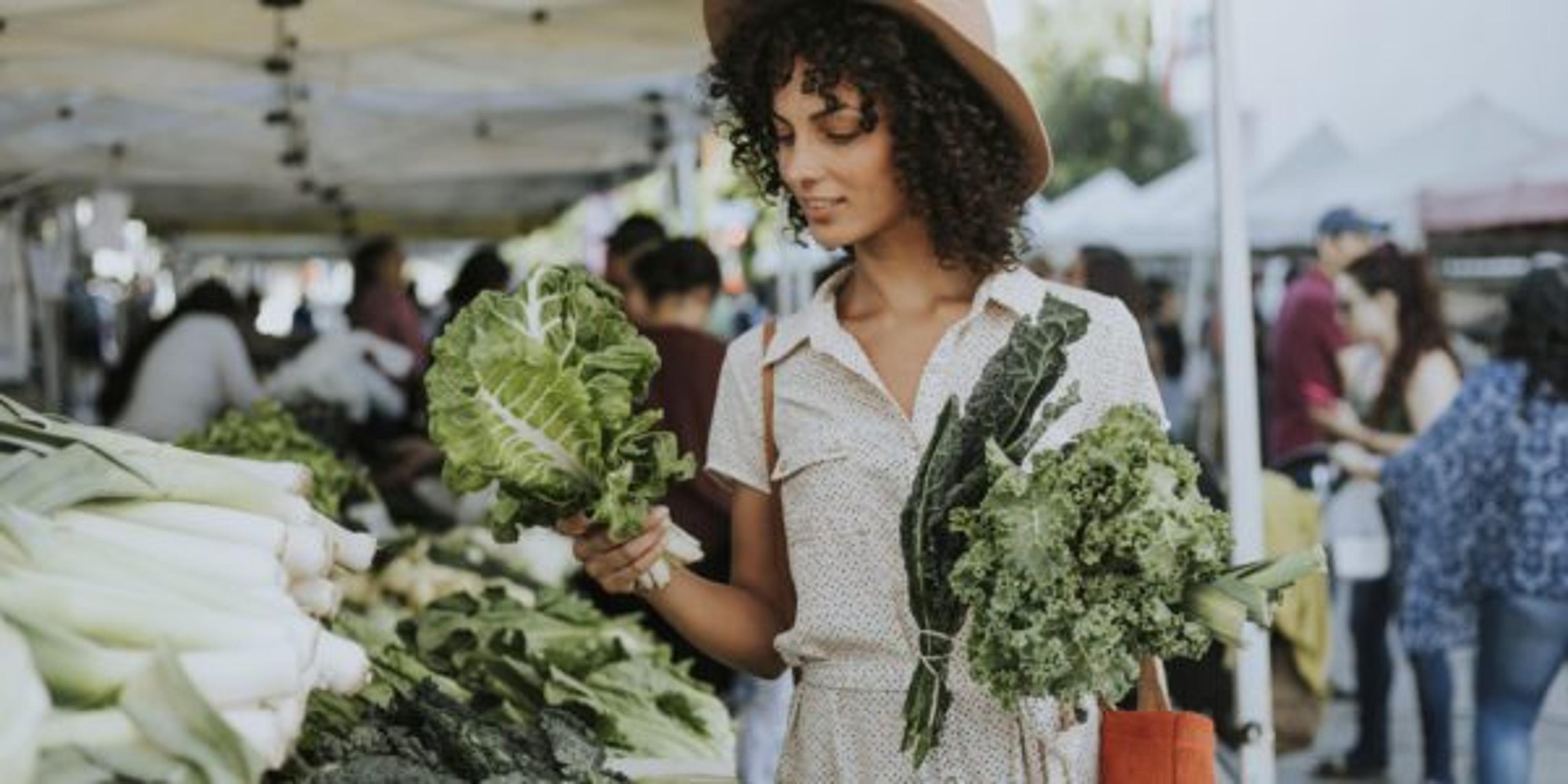 Woman buys kale at a farmer's market