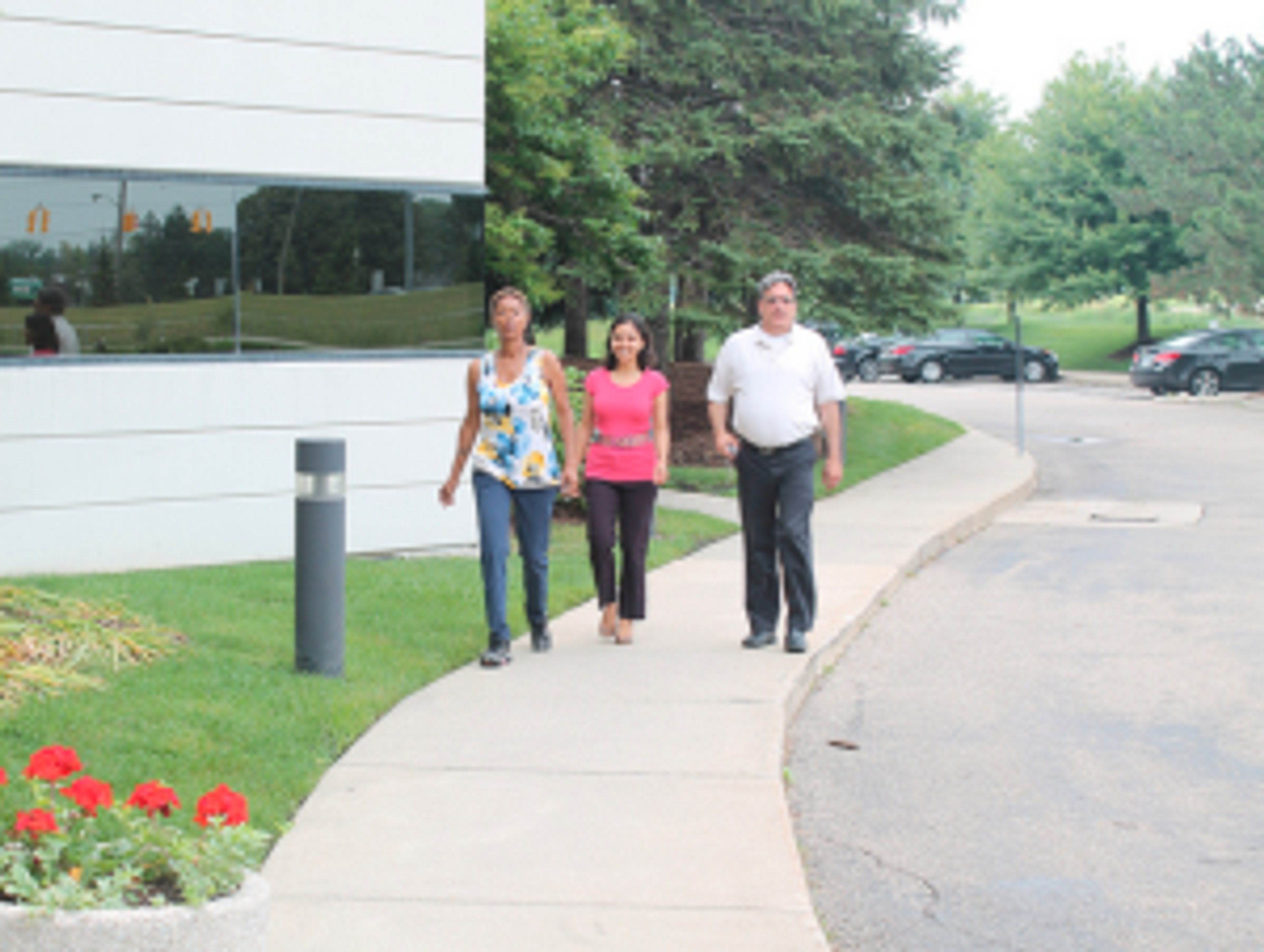 Deborah Rene, Jennifer Agrawal and Marvin Stepnak walk around the Essex Centre building in Southfield, MI to rack-up steps.