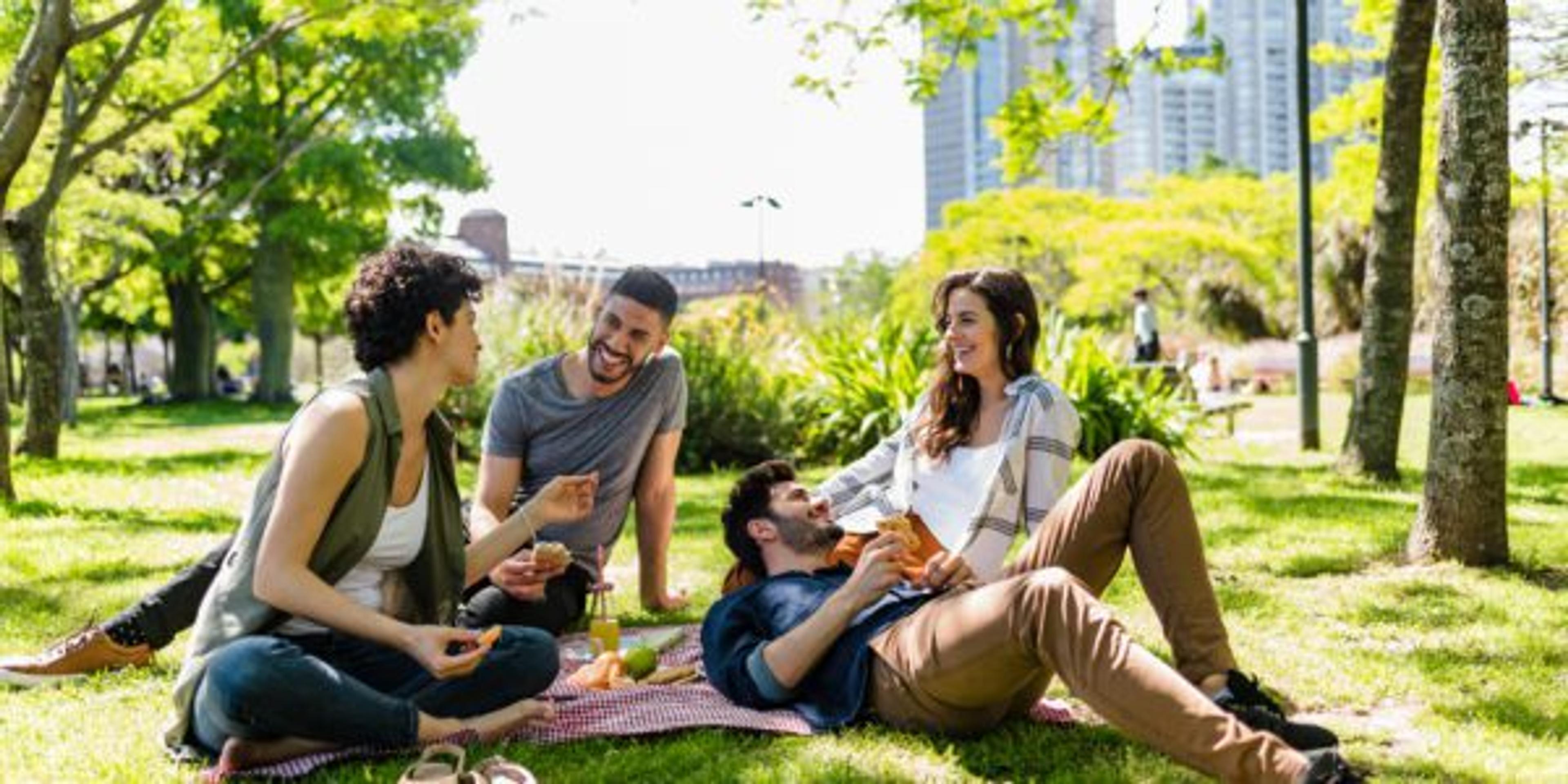 Friends sit outside for a picnic