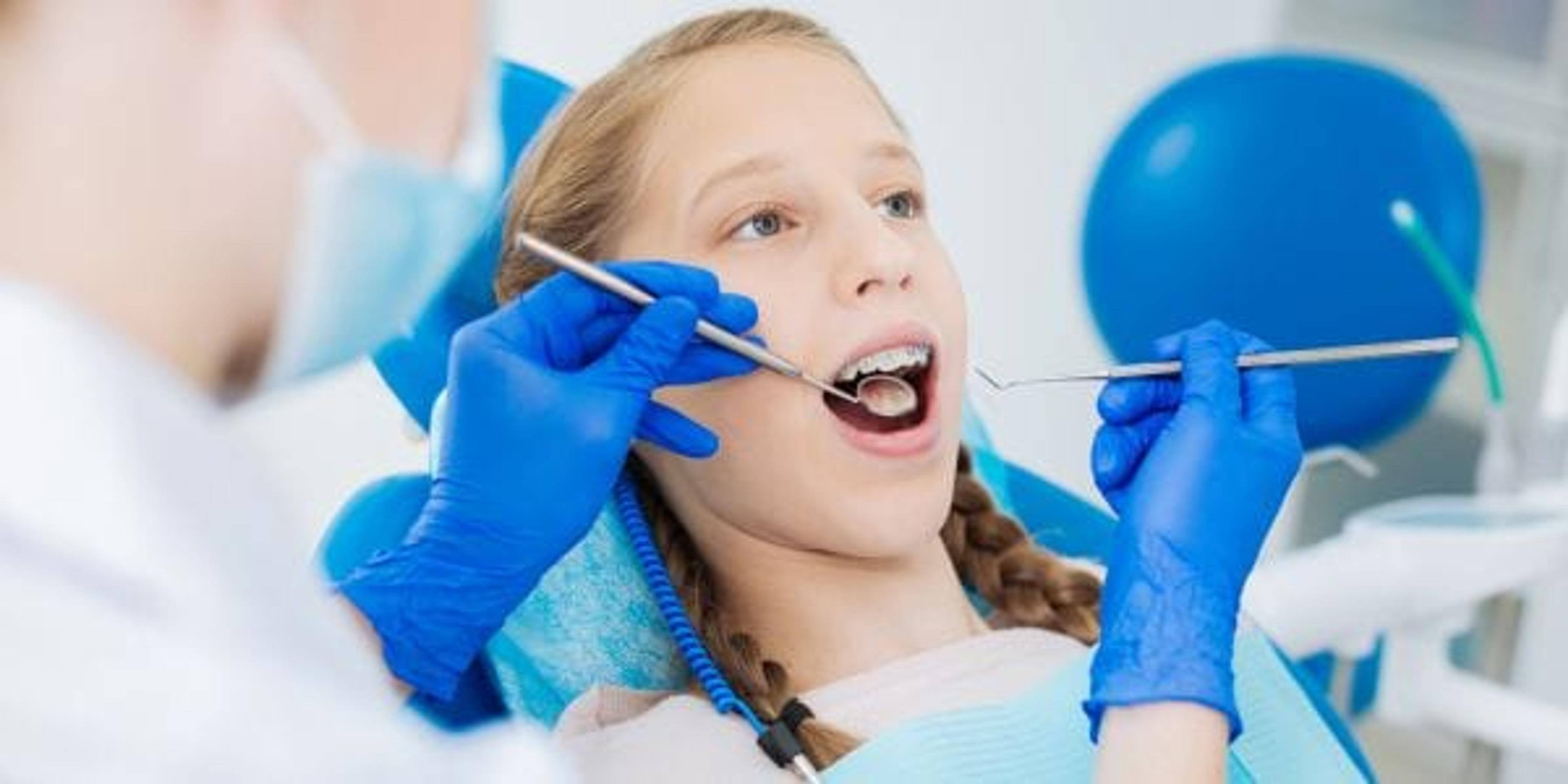 Blonde girl visiting a dentist