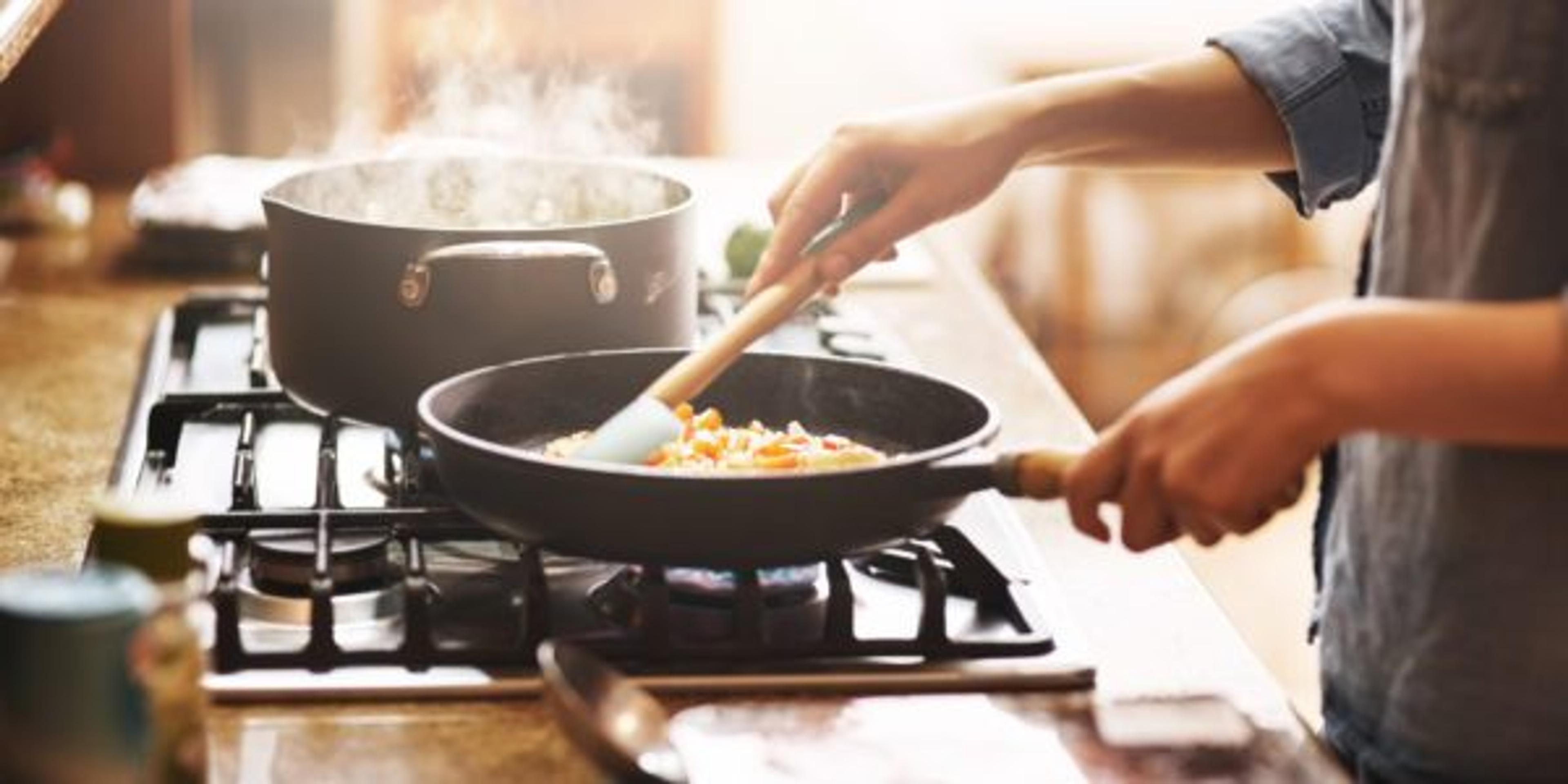 Woman cooks on a non-stick pain on the stove at home