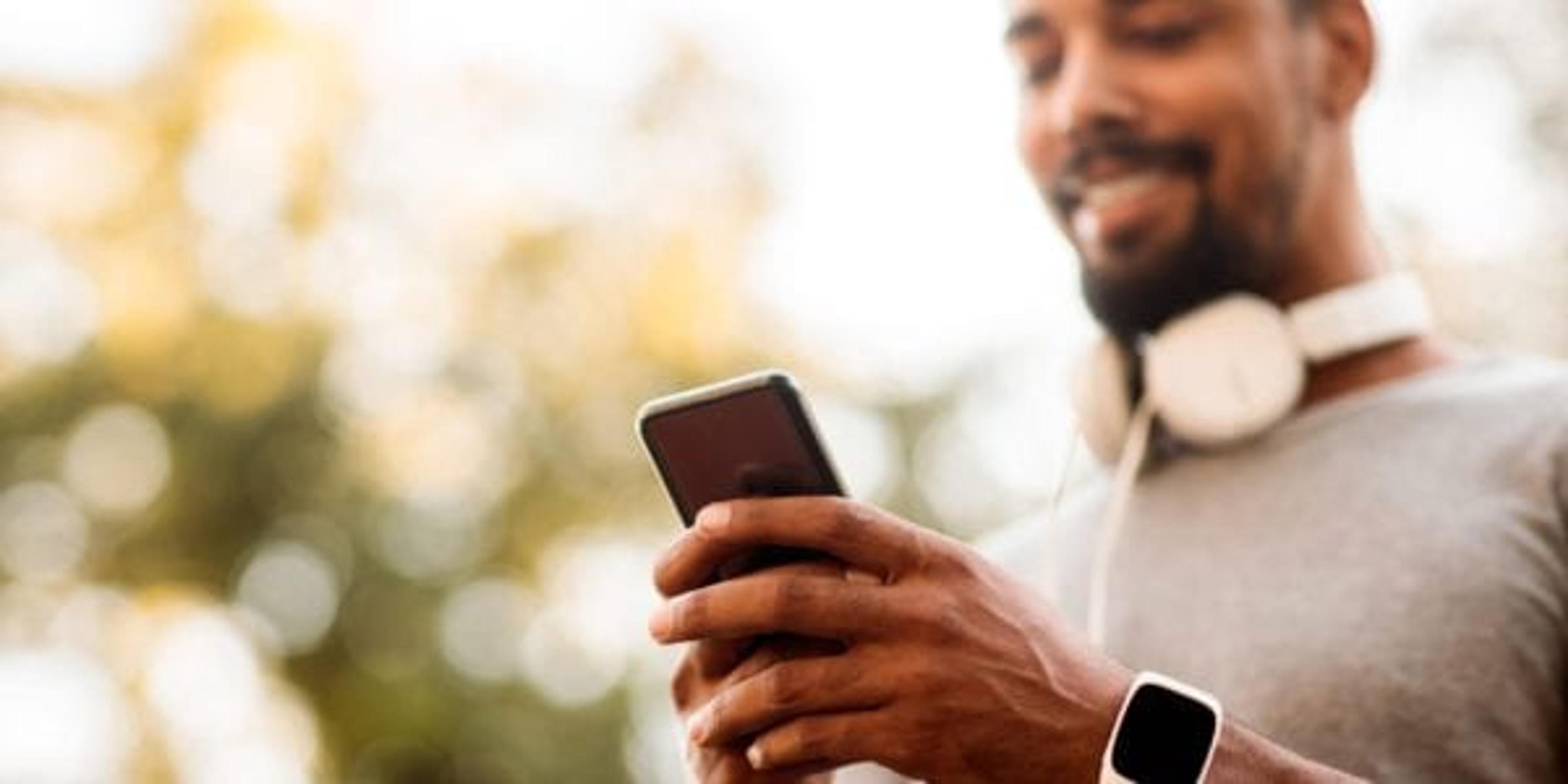 Man finishing up a workout and looking at his phone