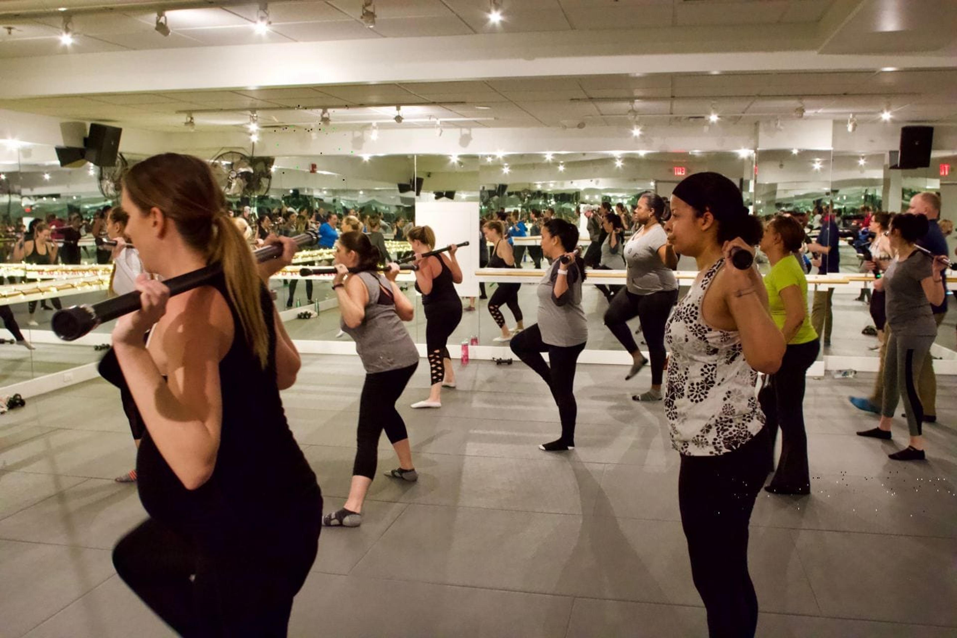 Image of class in session, with the author lifting the dreaded bar.