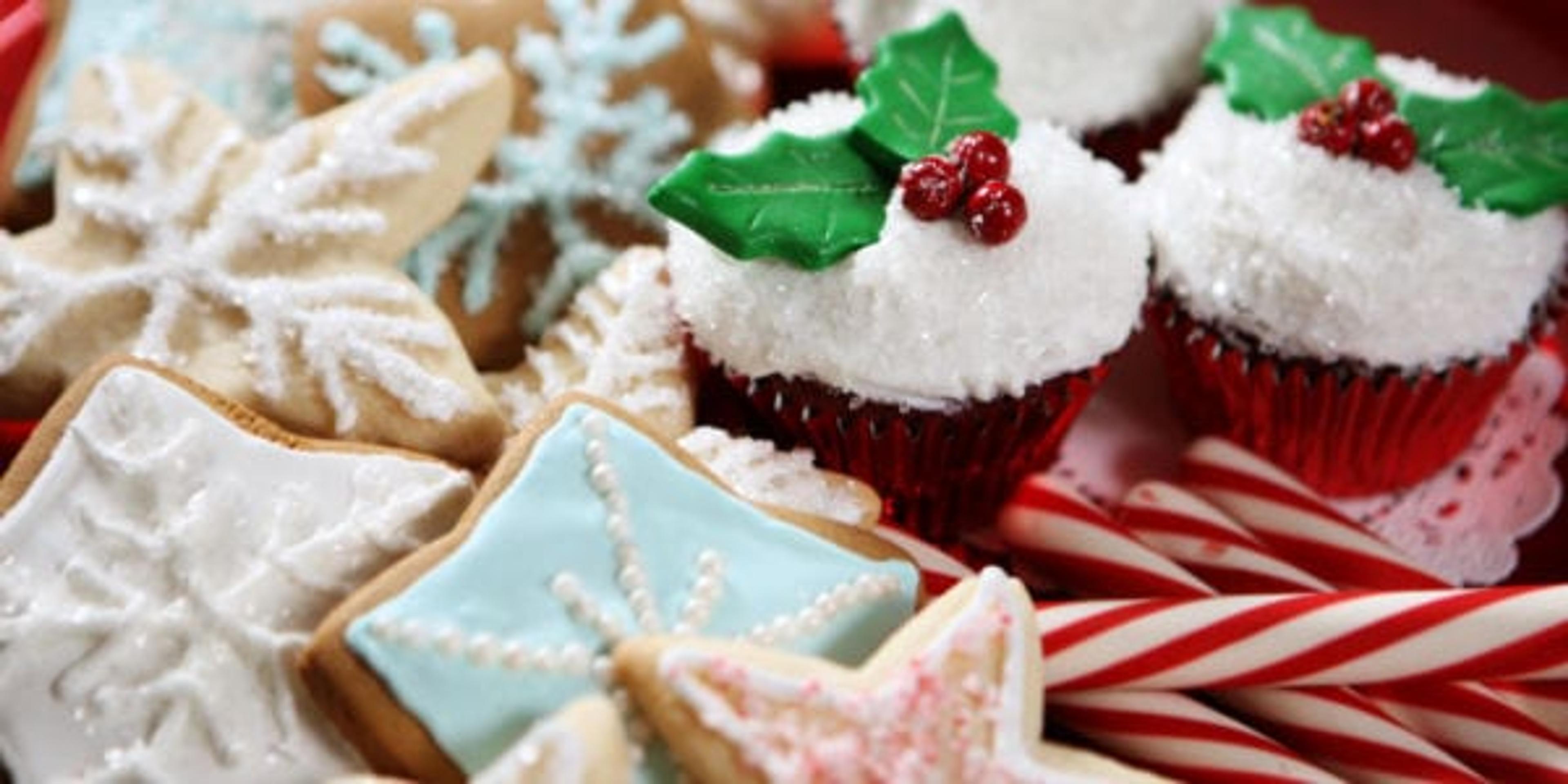 A plate of Christmas cookies, cupcakes and candy canes